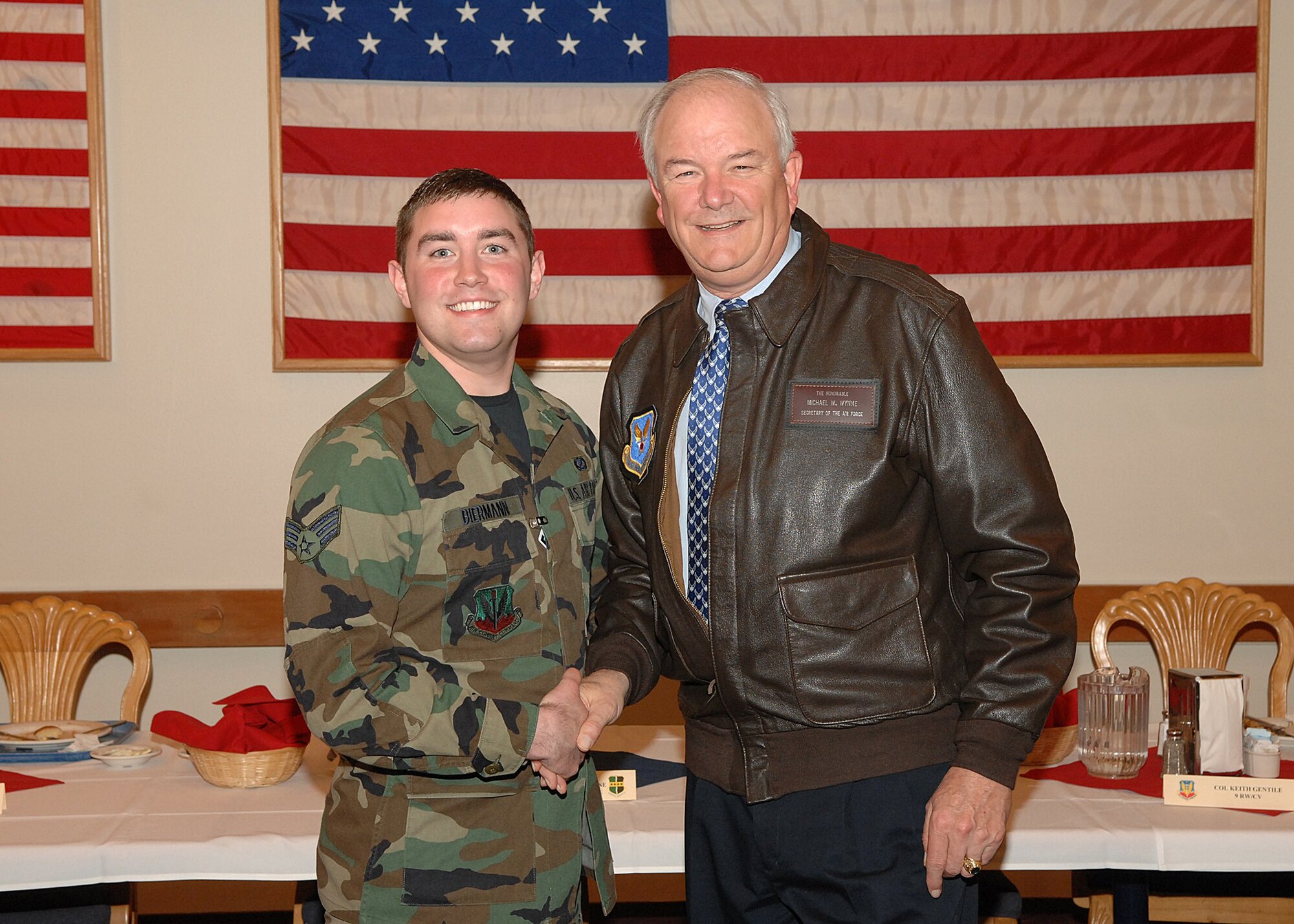 Then Senior Airman R.J. Biermann, 9th Reconnaissance Wing Public Affairs staff writer, shakes hands with former Secretary of the Air Force, Michael Wynne in the fall of 2007. Biermann gained 30 pounds from 2007 to 2008. (Courtesy photo)
