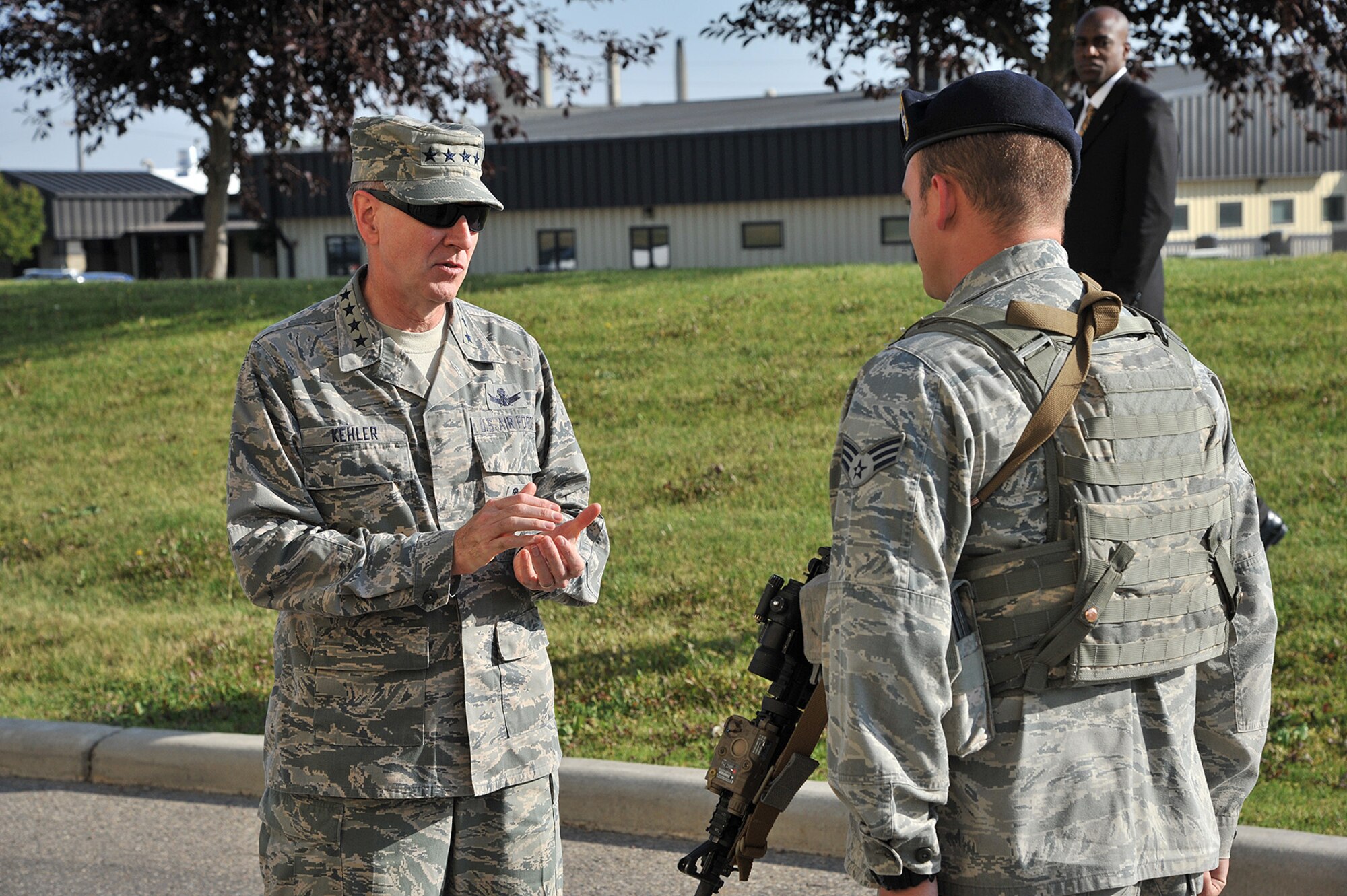 General C. Robert Kehler, U.S. Strategic Command commander, presents a commander’s coin to Senior Airman Brandyn Neuhaus, 741st Missile Security Forces Squadron member, for superior service and a job well done. Kehler recognized exceptional Airmen from around Malmstrom during his tour of the base July 31. (U.S. Air Force photo/John Turner)