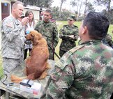 Lt. Col. Jerrod W. Killian (left), chief of clinical operations and command veterinarian for U.S. Army South, performs a physical exam on a Colombian military working dog with Colombian army veterinarians. Killian was part of an Army South delegation of Soldiers and civilians that traveled to Bogota, Colombia, to discuss the care, prevention and treatment of diseases military working dogs may incur. (Photo courtesy of U.S. Army South Public Affairs)