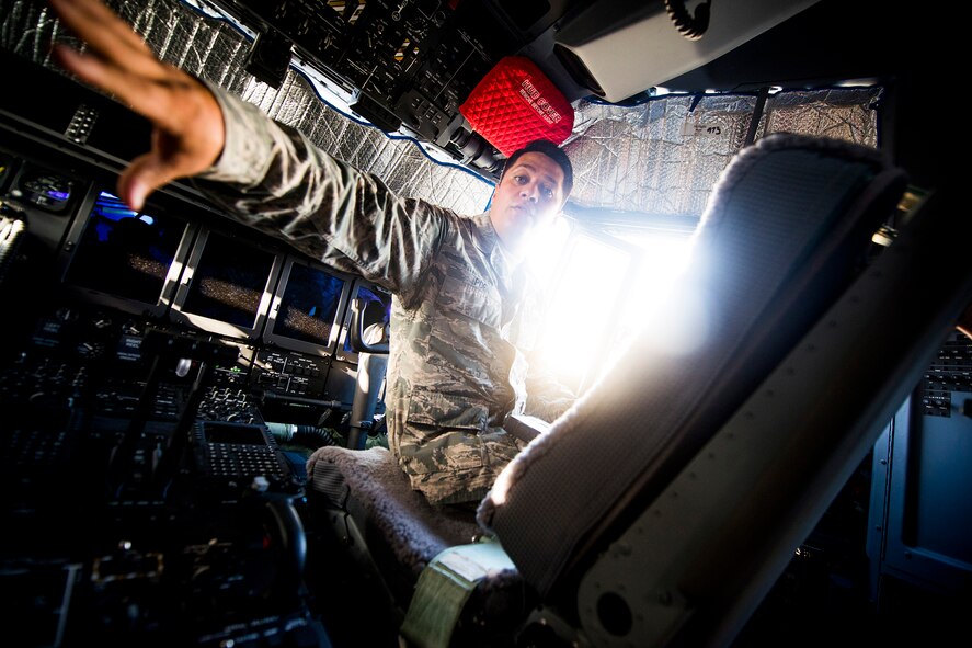 U.S. Air Force Tech. Sgt. David Poe, 372nd Training Squadron Detachment 9 C-130 airframe power plant general training instructor, discusses functions of an HC-130J Combat King II control panel during a field training detachment class at Moody Air Force Base, Ga., July 30, 2013. The new HC-130J features many upgrades from its predecessor, the HC-130P Combat King, including a nearly all-digital control panel. (U.S. Air Force photo by Staff Sgt. Jamal D. Sutter/Released) 