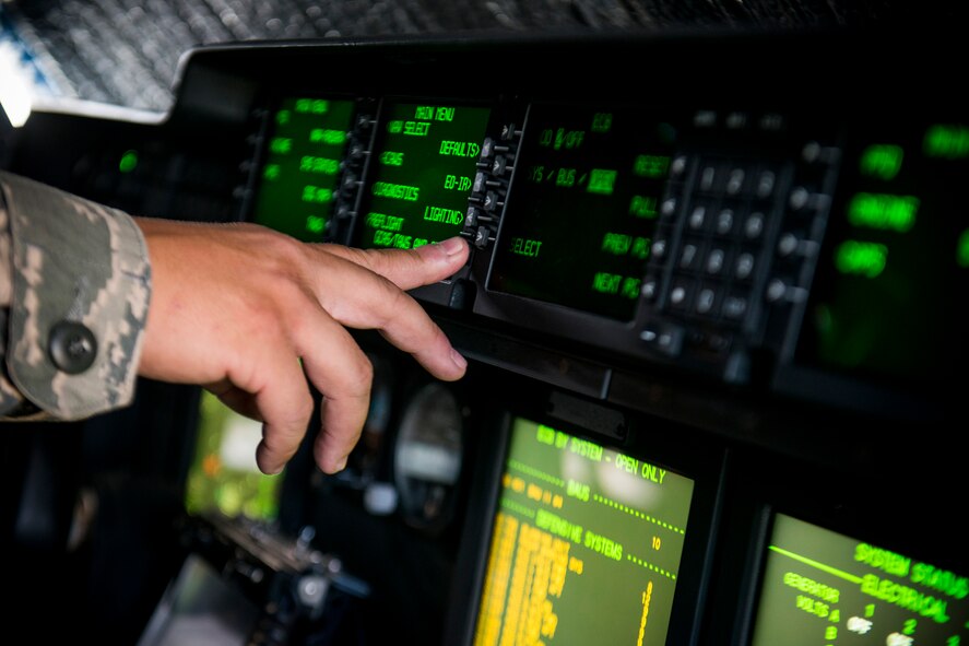 U.S. Air Force Tech. Sgt. David Poe, 372nd Training Squadron Detachment 9 C-130 airframe power plant general training instructor, operates an HC-130J Combat King II communication and navigation circuit-breaker panel during a field training detachment class at Moody Air Force Base, Ga., July 30, 2013. During the FTD class, Poe gave students and in-depth and hands-on demonstration on the aircraft’s various control systems. (U.S. Air Force photo by Staff Sgt. Jamal D. Sutter/Released) 