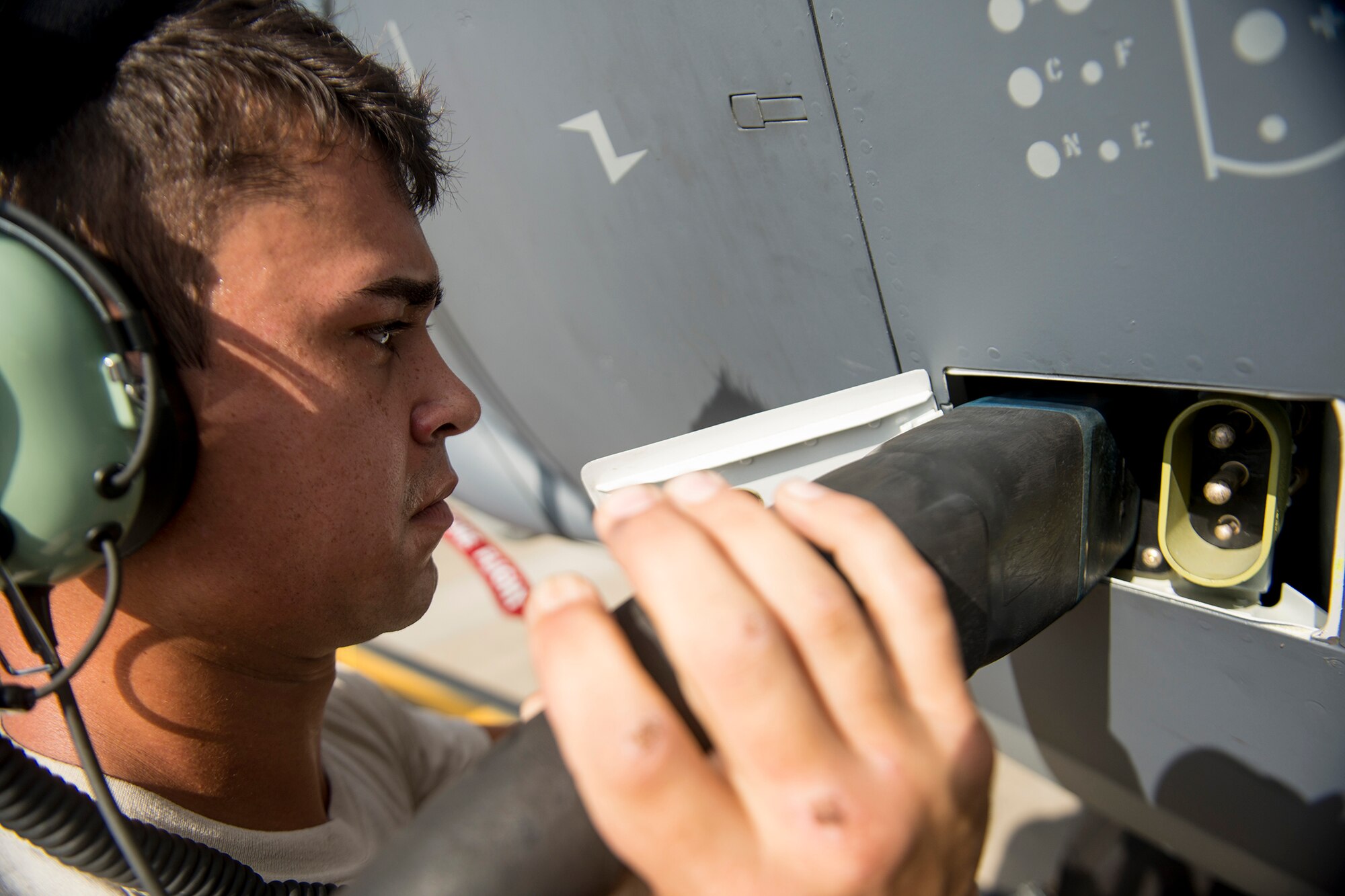 U.S. Air Force Senior Airman Stephen Battaglia, 723d Aircraft Maintenance Squadron crew chief, attaches an external power unit cord to an HC-130J Combat King II during a field training detachment class at Moody Air Force Base, Ga., July 30, 2013. Moody received its first HC-130J during an arrival ceremony July 19 and is currently training Airmen on the airframe and its systems. (U.S. Air Force photo by Staff Sgt. Jamal D. Sutter/Released) 
