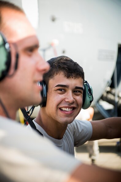 U.S. Air Force Senior Airman Stephen Battaglia, smiles as he assists Senior Airman Welsey Schwier in operating an air-conditioning cart during a field training detachment class at Moody Air Force Base, Ga., July 30, 2013. Battaglia and Schwier are both 723d Aircraft Maintenance Squadron crew chiefs currently enrolled it the FTD program to learn about the HC-130J Combat King II and how to operate its systems. (U.S. Air Force photo by Staff Sgt. Jamal D. Sutter/Released)