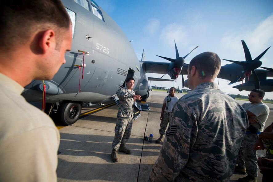 U.S. Air Force Tech. Sgt. David Poe, 372nd Training Squadron Detachment 9 C-130 airframe power plant general training instructor, leads an HC-130J field training detachment class at Moody Air Force Base, Ga., July 30, 2013. During the 15-day course, Airmen learn specifics on the new aircraft including applying power and operating its flight control and landing gear systems. (U.S. Air Force photo by Staff Sgt. Jamal D. Sutter/Released)