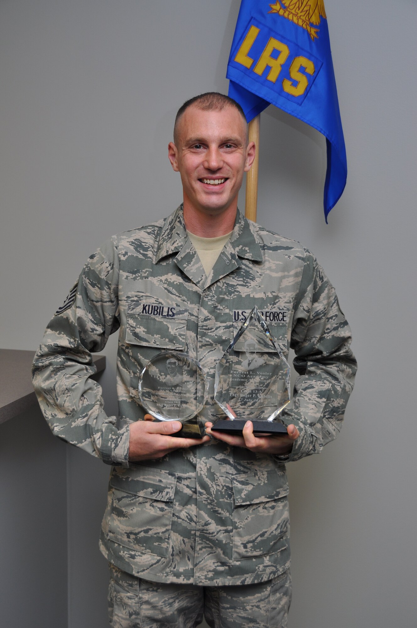 Technical Sgt. Roger Kubilis proudly displays the two plaques he recently received from the Non Commissioned Officer Academy in-residence course at Peterson AFB, Colo.  on July 17.  Kubilis was awarded the Academic Achievement Award and the Distinguished Graduate Award, beating out 125 other active duty, Guard and Reserve members in the class.  (U.S. Air Force photo/Senior Airman Mark Hybers)