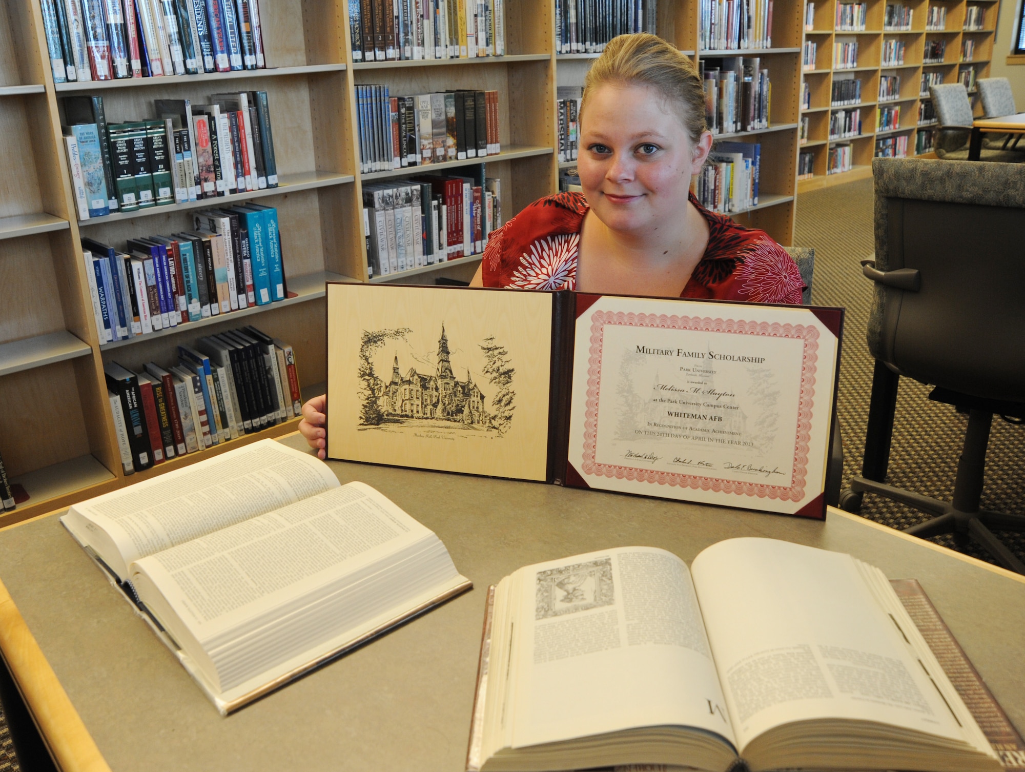 Melissa Slayton, wife of Christopher Slayton, 509th Maintenance Squadron aircraft recovery maintainer, received the Military Family Scholarship from Park University at Whiteman Air Force Base, Mo., August 8, 2013. Slayton was recognized for her academic achievement with a $4,000 scholarship for Park University. (U.S. Air Force photo by Airman 1st Class Bryan Crane/Released)
