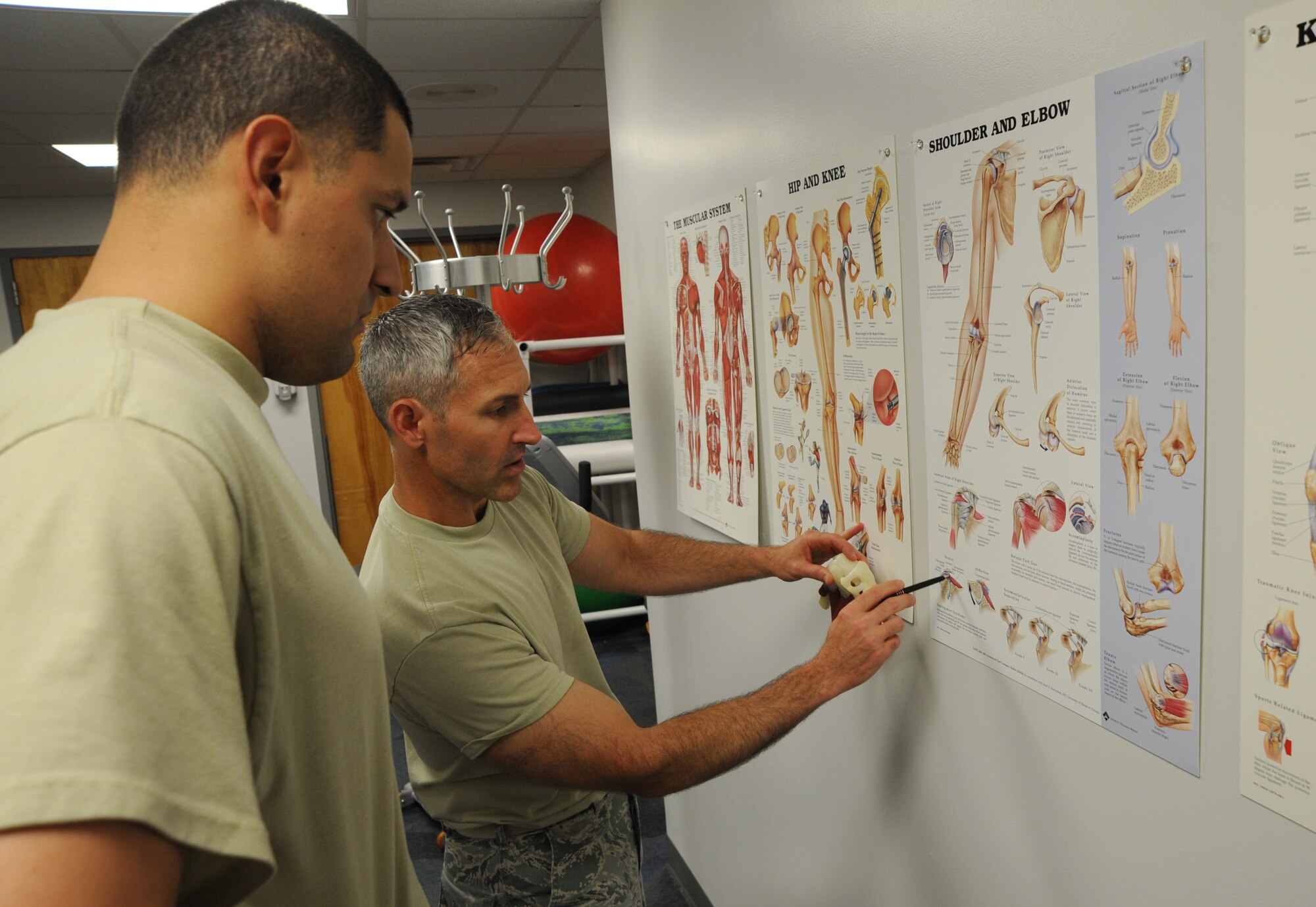 U.S. Air Force Maj. Michael Holmes, 509th Medical Operations Squadron physical therapy technician, reviews a chart with U.S. Air Force Staff Sgt. Tim Ferguson, 509th Maintenance Group command chief assistant, to explain the diagnosis of his injury at Whiteman Air Force Base, Mo., Aug. 6, 2013. The physical therapy clinic uses a variety of methods in providing evaluations, such as joint manipulation and mobilization, electrical stimulation, taping and bracing, and ultrasounds.  (U.S. Air Force photo by Airman 1st Class Bryan Crane/Released)