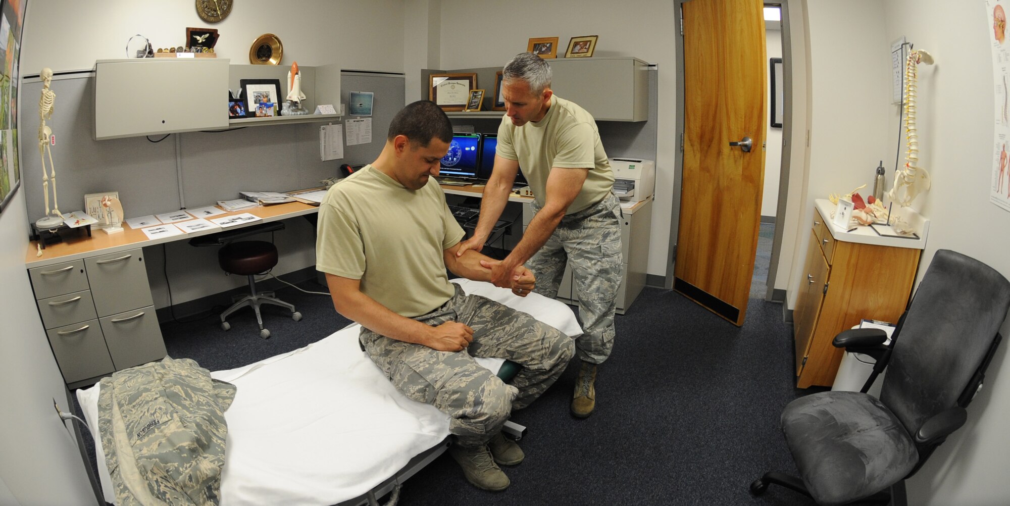 U.S. Air Force Maj. Michael Holmes, 509th Medical Operations Squadron physical therapy technician, conducts a strength exercise during an initial evaluation with U.S. Air Force Staff Sgt. Tim Ferguson, 509th Maintenance Group command chief assistant, at Whiteman Air Force Base, Mo., Aug. 6, 2013. The physical therapy clinic devises a program plan unique to each individual and his or her injuries. (U.S. Air Force photo by Airman 1st Class Bryan Crane/Released)