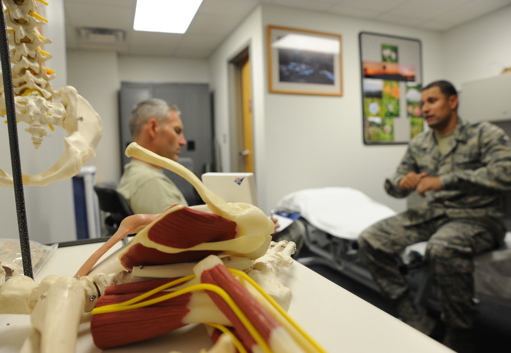 U.S. Air Force Maj. Michael Holmes, 509th Medical Operations Squadron physical therapy technician, conducts an initial evaluation with U.S. Air Force Staff Sgt. Tim Ferguson, 509th Maintenance Group command chief assistant, at Whiteman Air Force Base, Mo., Aug. 6, 2013. The physical therapy clinic treats patients with small injuries, such as minor sprains, all the way up to major injuries, such as post-operation surgery on knees and shoulders. (U.S. Air Force photo by Airman 1st Class Bryan Crane/Released)