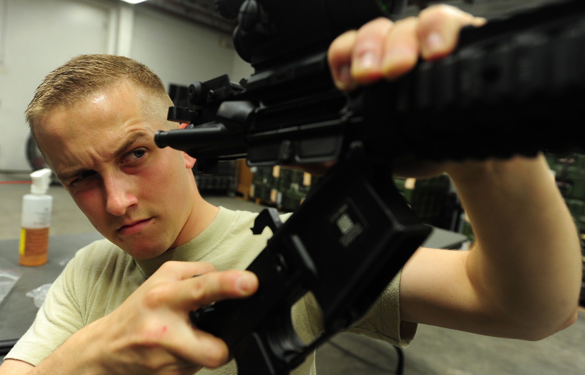 U.S. Air Force Airman 1st Class David Reddoch, 509th Logistics Readiness Squadron individual protective equipment technician, visually inspects the bolt-carrier group of an M4 carbine as part of a weapons-cleaning process at Whiteman Air Force Base, Mo. July 29, 2013. During the cleaning process, Airmen must ensure there is no build-up of carbon, dirt or any other foreign objects or substances that could affect the functionality of the weapon. (U.S. Air Force photo by Staff Sgt. Nick Wilson/Released)