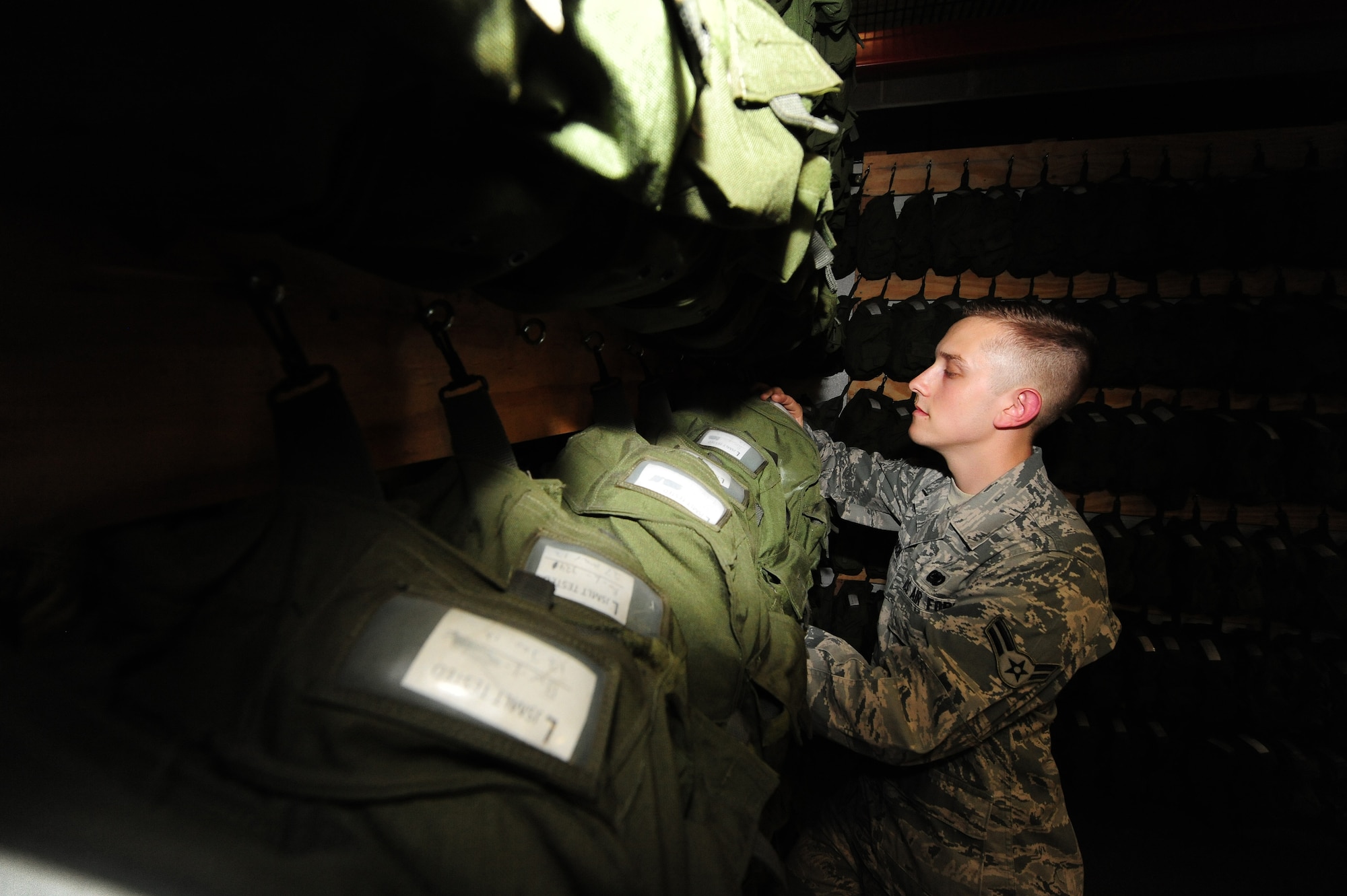 U.S. Air Force Airman 1st Class David Reddoch, 509th Logistics Readiness Squadron individual protective equipment technician, verifies inspection dates on gas masks as part of a routine assessment at Whiteman Air Force Base, Mo., July 29, 2013. Along with providing serviceable gas masks, IPE technicians have a mission to ensure the base populace is outfitted with serviceable life-saving equipment for training and deployments. (U.S. Air Force photo by Staff Sgt. Nick Wilson/Released)