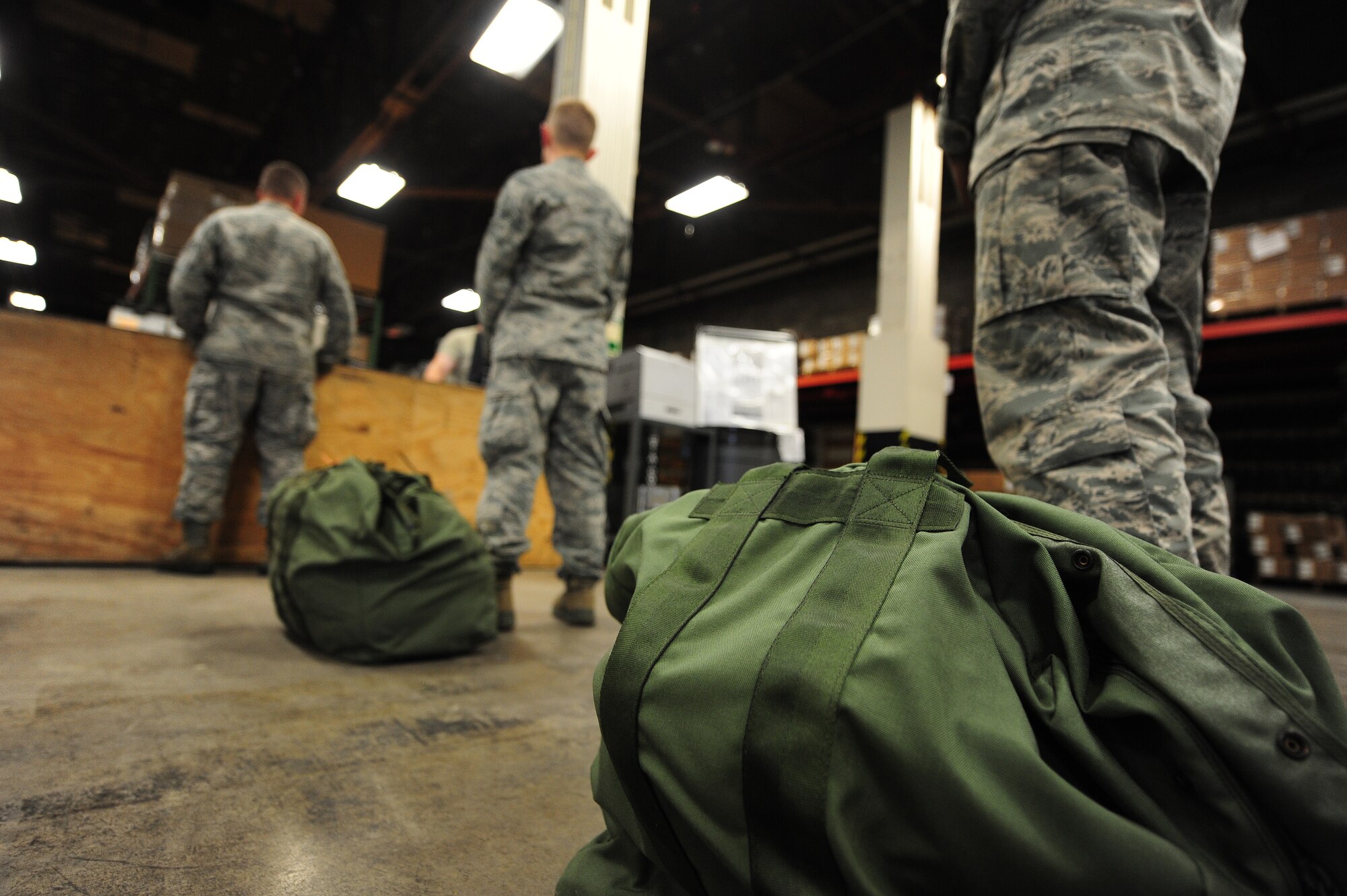 U.S. Air Force Airmen wait in line for assistance with chemical gear before participating in chemical, biological, radiological and nuclear (CBRNE) training at Whiteman Air Force Base, Mo., July 29, 2013. This training builds upon the CBRNE computer-based training, and enables Airmen to acquire hands-on experience by creating real-world scenarios designed to test their knowledge and skills when it comes to responding to CBRNE incidents. (U.S. Air Force photo by Staff Sgt. Nick Wilson/Released)