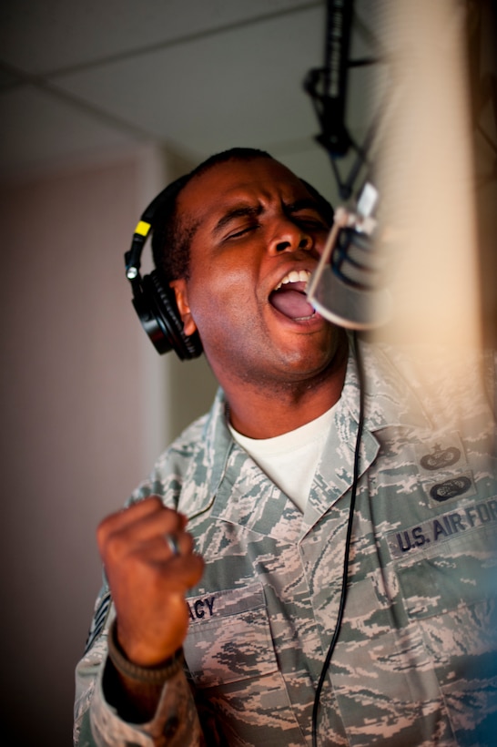 KUNSAN AIR BASE, Republic of Korea -- Staff Sgt. William Bracy, Armed Forces Network Kunsan radio DJ, performs his rendition of a song during an operational readiness exercise Aug. 9, 2013. Day or night during exercise Beverly Midnight 13-3, AFN takes music requests and entertains and informs Airmen on base. (U.S. Air Force photo by Senior Airman Armando A. Schwier-Morales/ Released)