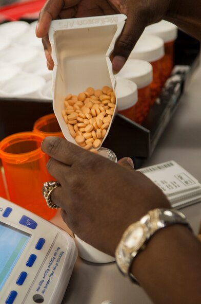 After counting a patient’s tablets twice, a 23d Medical Group pharmacy technician pours them into a bottle at Moody Air Force Base, Ga., Aug. 5, 2013. Moody’s pharmacy fills an average of 12,000 prescriptions a month and serves approximately 11,000 beneficiaries in Florida and Georgia. (U.S. Air Force photo by Airman 1st Class Sandra Marrero/released)
