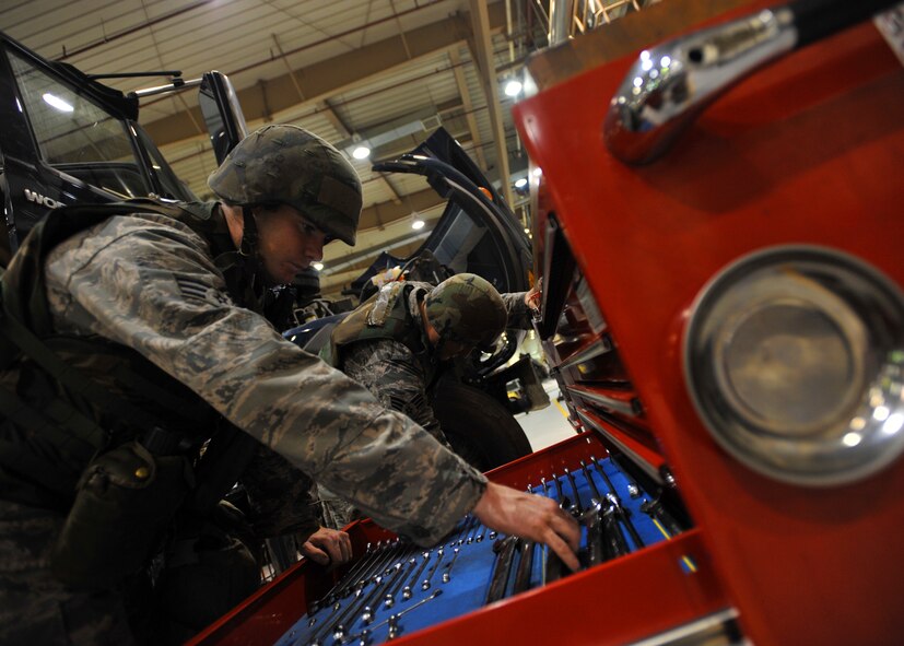 Senior Airmen Sean Collins and Michael Geer, 51st Logistics Readiness Squadron vehicle maintenance technicians, search for tools during Operational Readiness Exercise Beverly Midnight 13-03 at Osan Air Base, Republic of Korea, Aug. 9, 2013. Osan Airmen are in the fourth simulated wartime contingency exercise executed in 2013 that will test the base's ability to defend and execute the mission in a heightened state of readiness. (U.S. Air Force photo/Senior Airman Siuta B. Ika)