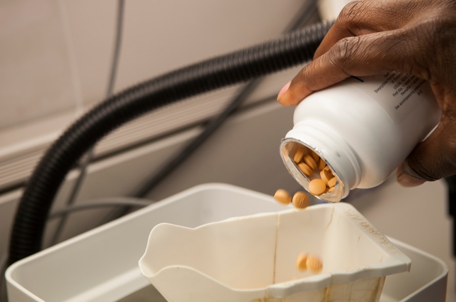 A 23d Medical Group pharmacy technician uses a digitalized scale to count medications at Moody Air Force Base, Ga., Aug. 5, 2013. This and three other pieces of automation are used to ensure the safe filling of prescriptions. (U.S. Air Force photo by Airman 1st Class Sandra Marrero/released)
