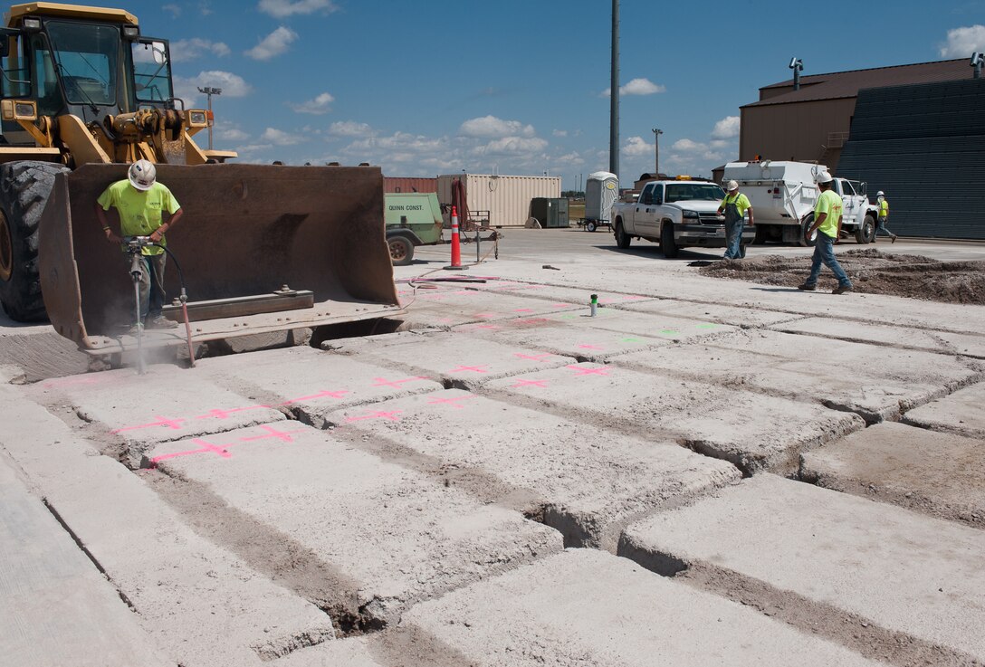 Quinn Construction and Complete Contracting Solutions workers prepare to excavate concrete slabs from B-1 parking spots during flighline reconstruction project at Ellsworth Air Force Base, S.D., Aug. 5, 2013. Three rows of aircraft parking spots will be renovated to ensure the integrity of Ellsworth’s aircraft parking area. (U.S. Air Force photo by Airman 1st Class Alystria Maurer/Released)