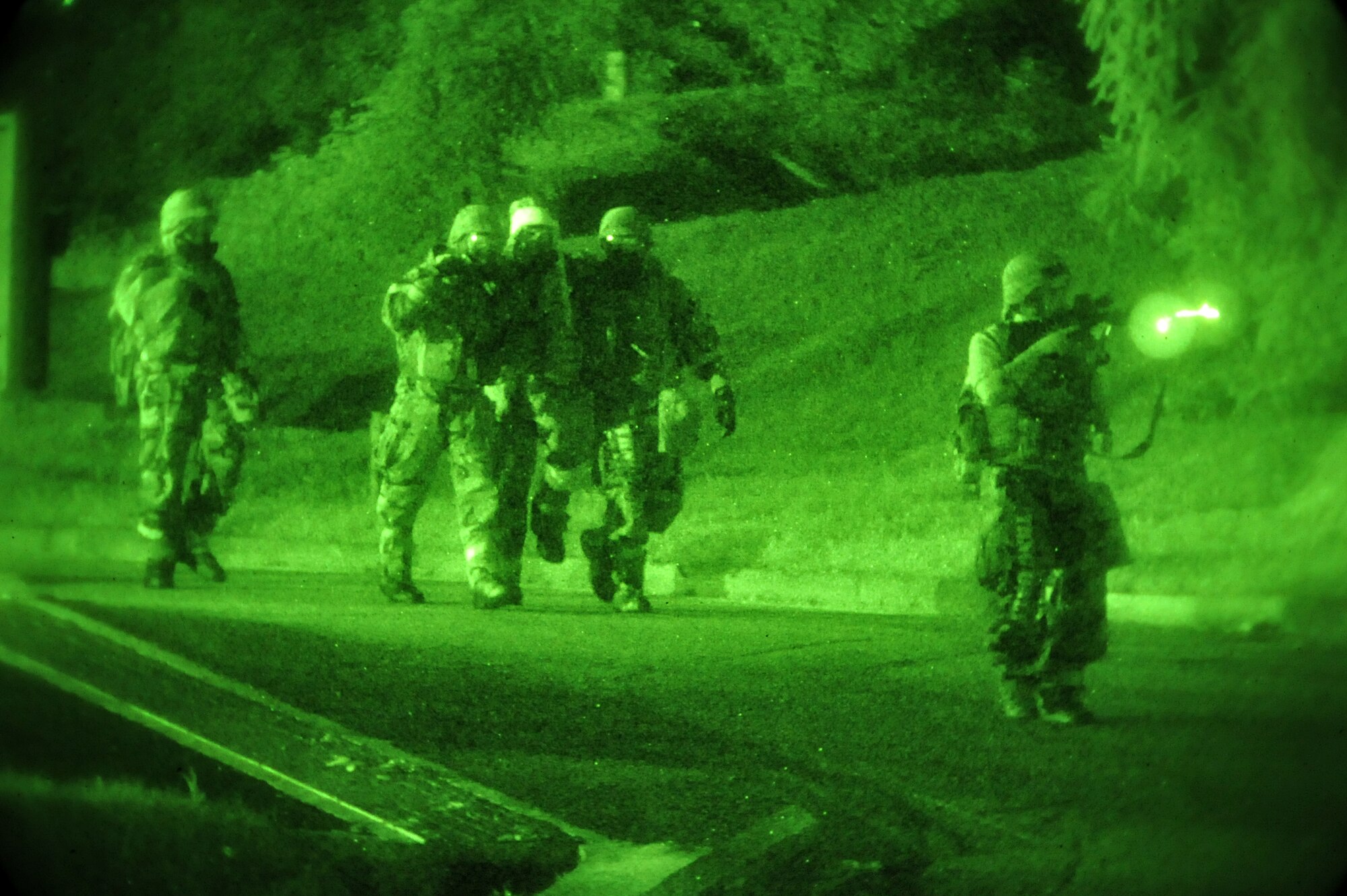 A Member of the 51st Security Forces Squadron ensures the last members of the emergency operations center are secured as they evacuate a building during Operational Readiness Exercise Beverly Midnight 13-03 at Osan Air Base, Republic of Korea, Aug. 8, 2013. The exercise highlights Osan Airmen’s ability to position, employ and sustain forces, and showcase operational readiness. (U.S. Air Force photo/Staff Sgt. Emerson Nuñez)