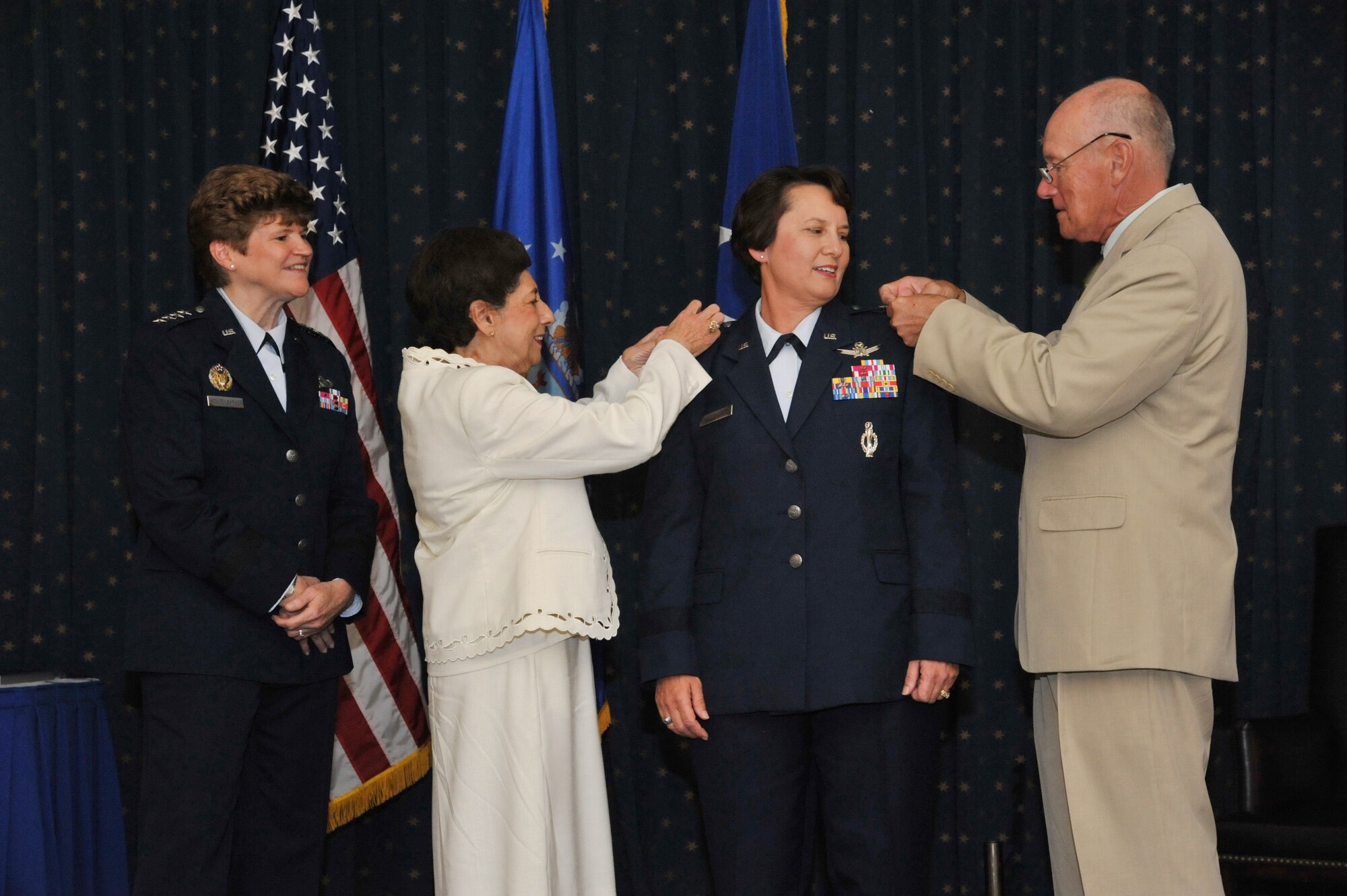 Maj. Gen. Sandra Finan, Air Force Nuclear Weapons Center commander, receives her second star during a pinning on ceremony Aug. 2 at the Mountain View Club. Her mother, Margaret Chase, and husband, Chuck, pin the stars, while Gen. Janet Wolfenbarger, Air Force Materiel Command commander, presides.  Finan was frocked to major general in April. (Photo by Ken Moore)