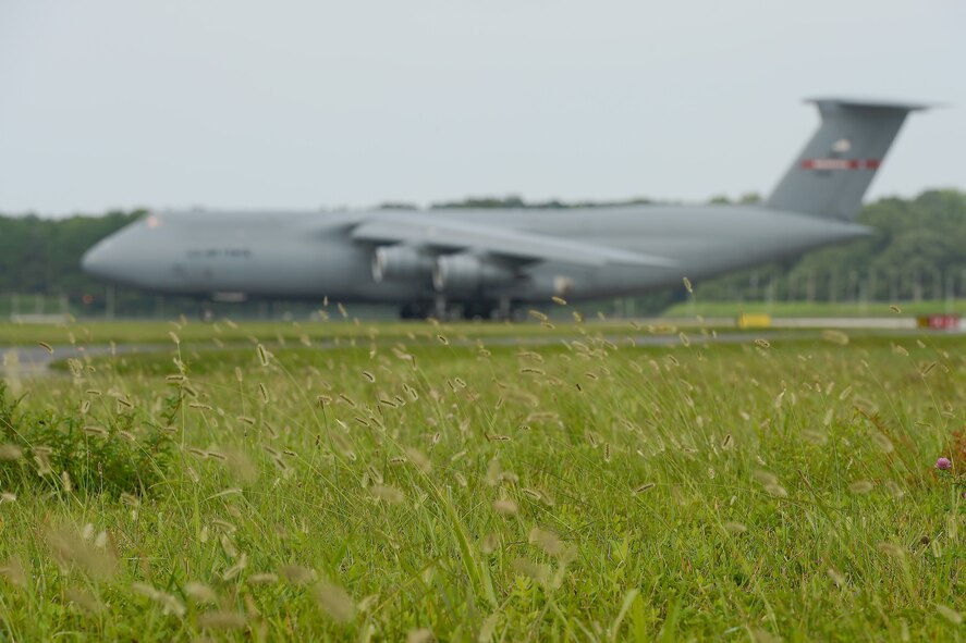 C-5A Galaxy, serial # 69-0014, taxis in to park at Dover Air Force Base to complete its' transfer from the Tennessee Air National Guard's 164th Airlift Wing to its' new home at the Air Mobility Command Museum at Dover, August 7, 2013. Zero-One-Four was assigned to Dover from 1973-1977 and during that time was the platform aircaft for the first and only inter-continental ballistic missile launch from a cargo aircraft in-flight. The C-5 Galaxy is the largest transport in the U.S. military and the Lockheed built aircraft is the first Galaxy to be retired to a museum open to the public. (U.S. Air Force photo/Greg L. Davis)
