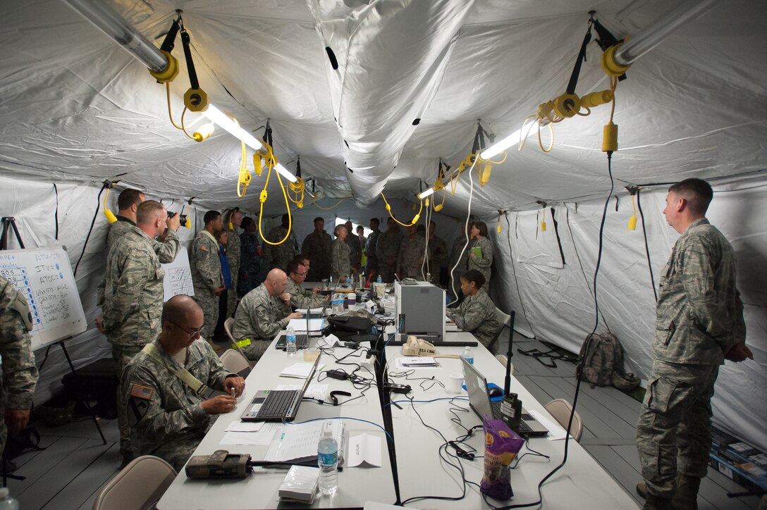 Maj. Gen. Barbara Faulkenberry, vice commander of 18th Air Force, visits the Joint Operations Center tent during Exercise Gateway Relief at MidAmerica St. Louis Airport in Mascoutah, Ill., on Aug. 7, 2013. The Kentucky Air National Guard's 123rd Contingency Response Group and the U.S. Army’s 689th Rapid Port Opening Element in Fort Eustis, Va., have teamed up for the U.S. Transportation Command-directed exercise through Aug. 9, executing the reception and distribution of earthquake-relief supplies. (U.S. Air National Guard photo by Maj. Dale Greer)