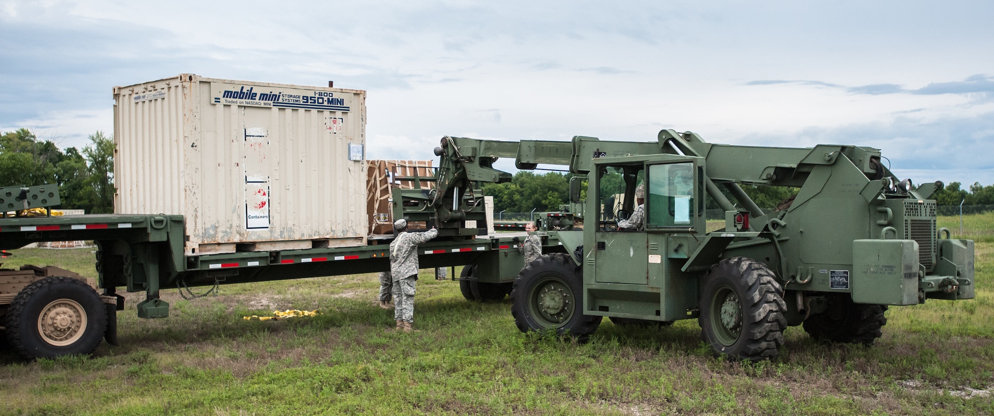 Army Spc. Brandon Glaspie and Army Pfc. Loura Wiggs of the U.S. 689th Army’s Rapid Port Opening Element in Fort Eustis, Va., direct the placement of a pallet of disaster-relief supplies onto a flat-bed truck at MidAmerica St. Louis Airport in Mascoutah, Ill., on Aug. 7, 2013, as part of Exercise Gateway Relief, a U.S. Transportation Command-directed earthquake-response scenario. The Soldiers were working at the forward node of a Joint Task Force-Port Opening, where relief supplies that arrive by air are staged for further movement over land by trucks. The Kentucky Air National Guard's 123rd Contingency Response Group operated the airlift side of the JTF-PO, known as an Aerial Port of Debarkation. (U.S. Air National Guard photo by Maj. Dale Greer)