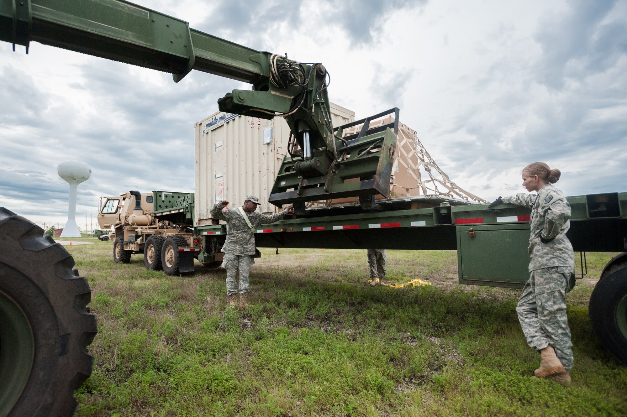 Army Spc. Brandon Glaspie and Army Pfc. Loura Wiggs of the U.S. 689th Army’s Rapid Port Opening Element in Fort Eustis, Va., direct the placement of a pallet of disaster-relief supplies onto a flat-bed truck at MidAmerica St. Louis Airport in Mascoutah, Ill., on Aug. 7, 2013, as part of Exercise Gateway Relief, a U.S. Transportation Command-directed earthquake-response scenario. The Soldiers were working at the forward node of a Joint Task Force-Port Opening, where relief supplies that arrive by air are staged for further movement over land by trucks. The Kentucky Air National Guard's 123rd Contingency Response Group operated the airlift side of the JTF-PO, known as an Aerial Port of Debarkation. (U.S. Air National Guard photo by Maj. Dale Greer)