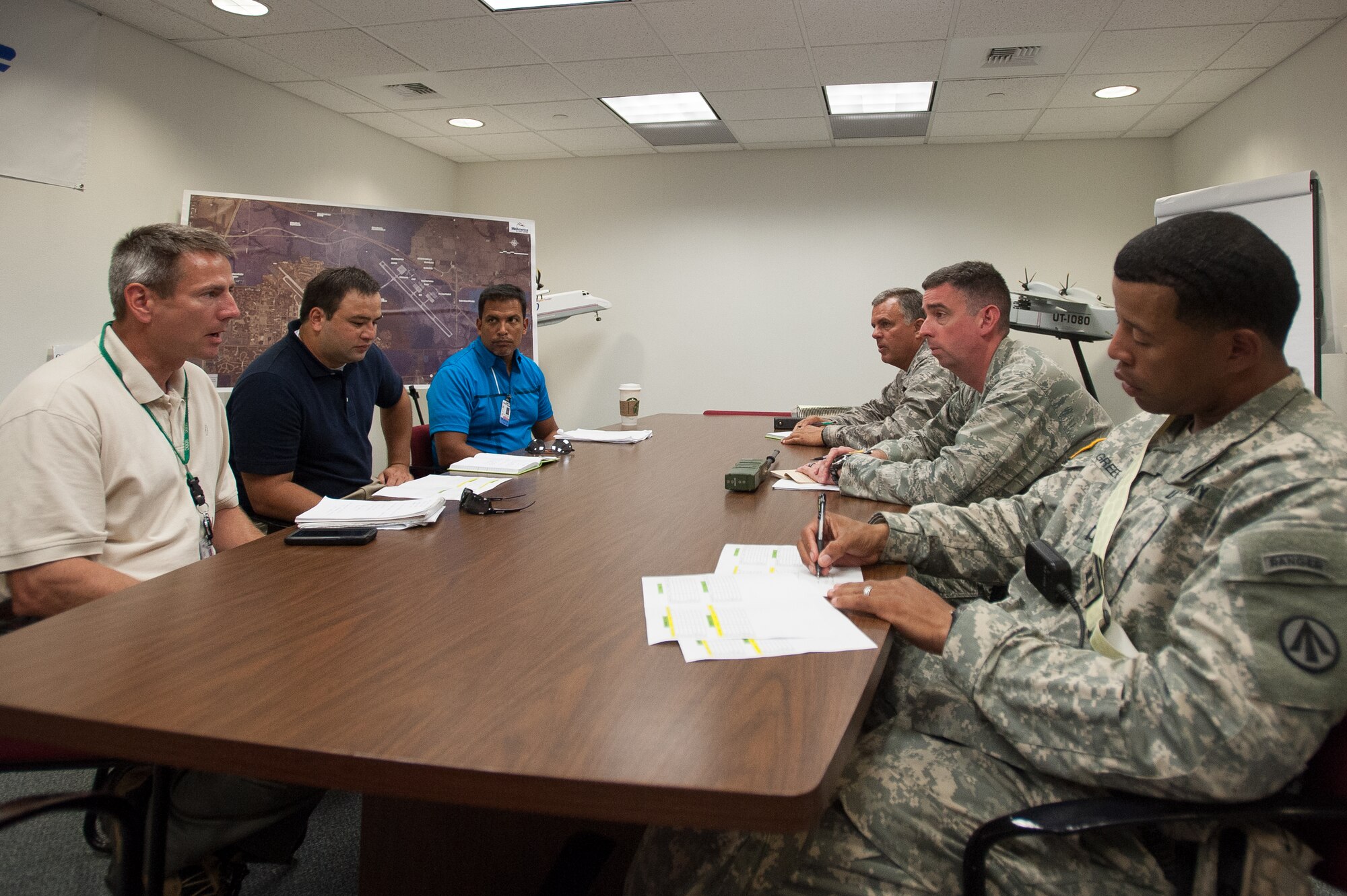 Col. Mark Heiniger, commander of the Kentucky Air National Guard’s 123rd Contingency Response Group, Lt. Col. Bruce Bancroft, director of the Joint Operations Center for Exercise Gateway Relief, and Capt. Charles Greene, commander of the U.S. Army’s 689th Rapid Port Opening Element in Fort Eustis, Va., brief notional representatives from the Federal Emergency Management Agency at MidAmerica St. Louis Airport in Mascoutah, Ill., on Aug. 7, 2013, as part of a U.S. Transportation Command-directed earthquake-relief scenario. The 123rd is teaming up with the 689th through Aug. 9 to operate a Joint Task Force-Port Opening, which combines an Air Force Aerial Port of Debarkation with an Army trucking and distribution unit. (U.S. Air National Guard photo by Maj. Dale Greer)