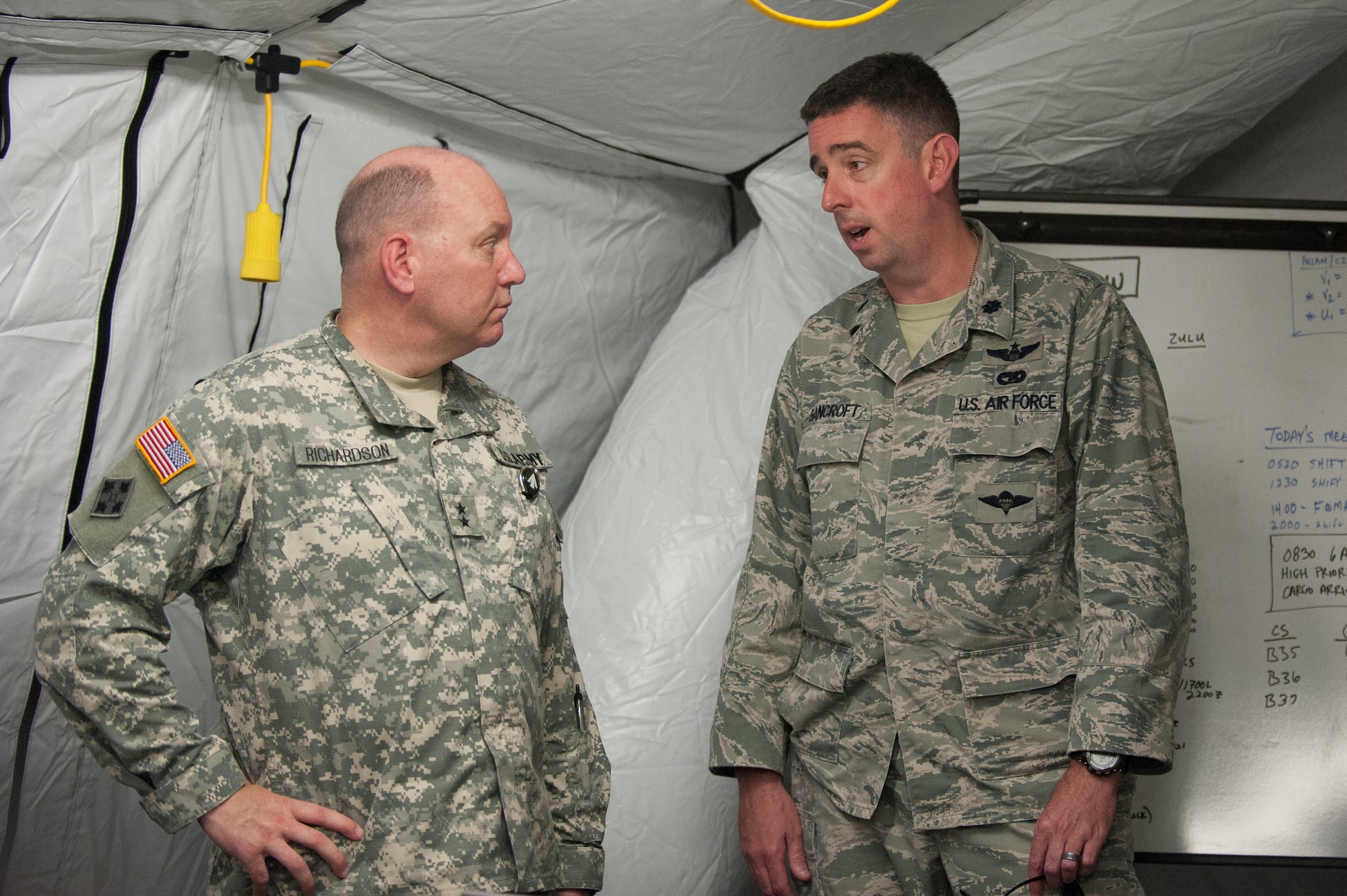 Army Maj. Gen. Thomas Richardson (left), commander of the Surface Deployment and Distribution Command, discusses Exercise Gateway Relief with the Kentucky Air National Guard’s Lt. Col. Bruce Bancroft, director of the Joint Operations Center at MidAmerica St. Louis Airport in Mascoutah, Ill., on Aug. 7, 2013. The Kentucky Air Guard’s 123rd is teaming up with the U.S. Army’s 689th Rapid Port Opening Element from Fort Eustis, Va., through Aug. 9 to operate a Joint Task Force-Port Opening, combining an Air Force Aerial Port of Debarkation with an Army trucking and distribution unit. (U.S. Air National Guard photo by Maj. Dale Greer)