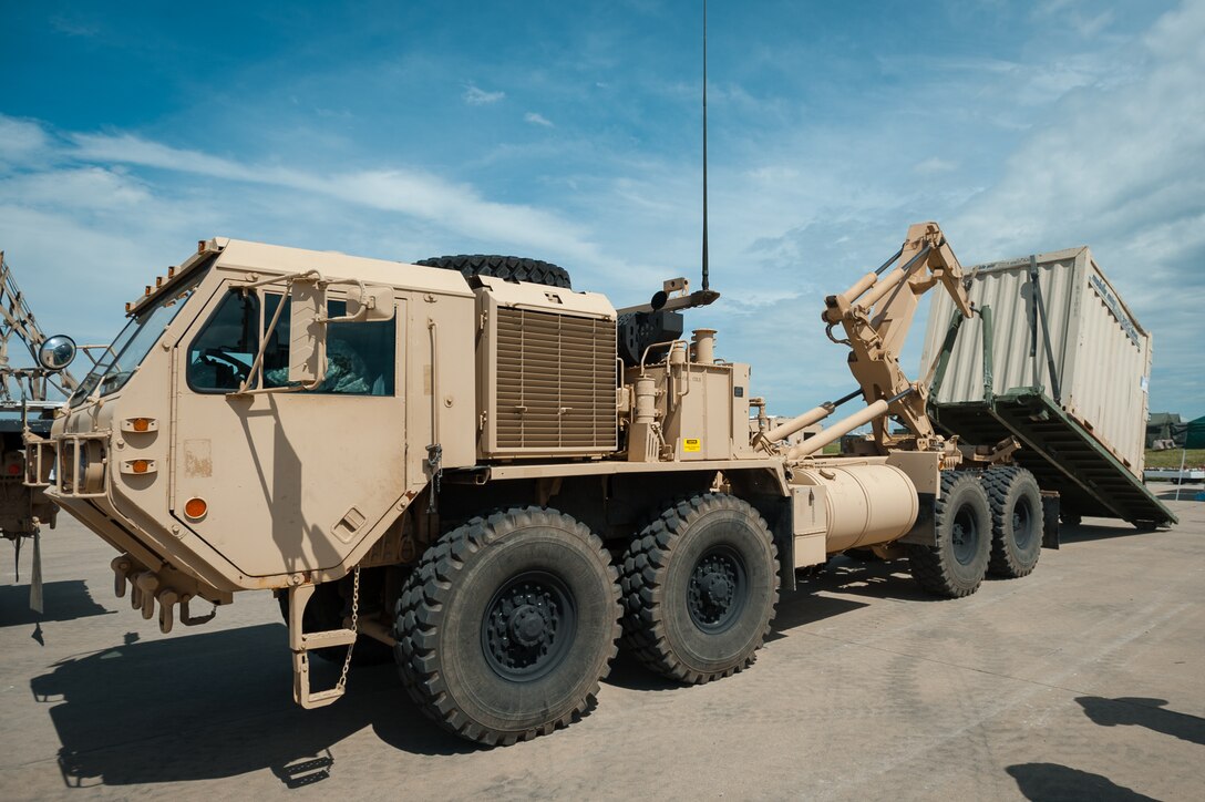 Soldiers from the U.S. Army’s 689th Rapid Port Opening Element in Fort Eustis, Va., load simulated disaster-relief supplies onto a Load Handling System truck on the flight line of MidAmerica St. Louis Airport in Mascoutah, Ill., on Aug. 7, 2013 as part of Exercise Gateway Relief, a U.S. Transportation Command-directed earthquake-relief scenario. The cargo will be hauled to a forward node, where it will be staged for further movement over land by trucks. The 689th is teaming up with the Kentucky Air National Guard’s 123rd Contingency Response Group through Aug. 9 for the exercise. (U.S. Air National Guard photo by Maj. Dale Greer)