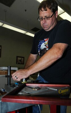 John Berry, 28th Force Support Squadron Arts and Crafts Skills Development Center recreation assistant, uses a Cassese to press small clips to re-enforce corners of a frame at the Arts and Crafts Center on Ellsworth Air Force Base, S.D., Aug. 1, 2013. The base's arts and crafts program was selected as the best in ACC for their innovative techniques and exceptional range of services for Airmen. (U.S. Air Force photo by Airman 1st Class Rebecca Imwalle/Released)