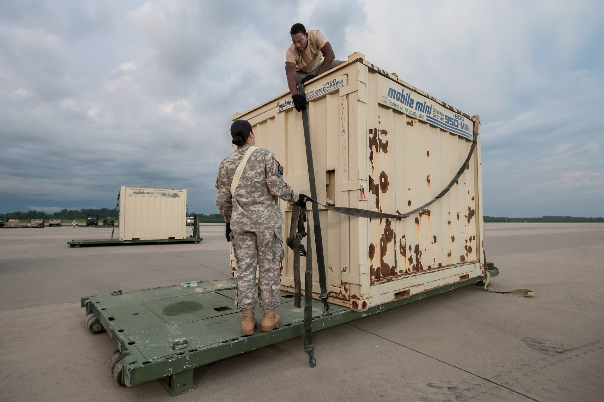 Army Sgt. Brenda Acuna and Army Spc. Marquis Talbot of the U.S. Army’s 689th Rapid Port Opening Element in Fort Eustis, Va., strap simulated disaster-relief supplies to a flat-rack pallet on the flight line of MidAmerica St. Louis Airport in Mascoutah, Ill., on Aug. 7, 2013, as part of Exercise Gateway Relief, a U.S. Transportation Command-directed earthquake-response scenario. The 689th is joining with the Kentucky Air National Guard’s 123rd Contingency Response Group to stand up and operate a Joint Task Force-Port Opening through Aug. 9. The JTF-PO, which combines an Air Force Aerial Port of Debarkation with an Army trucking and distribution unit, ensures the smooth flow of relief supplies into affected areas by airlift and coordinates final distribution over land. (U.S. Air National Guard photo by Maj. Dale Greer)