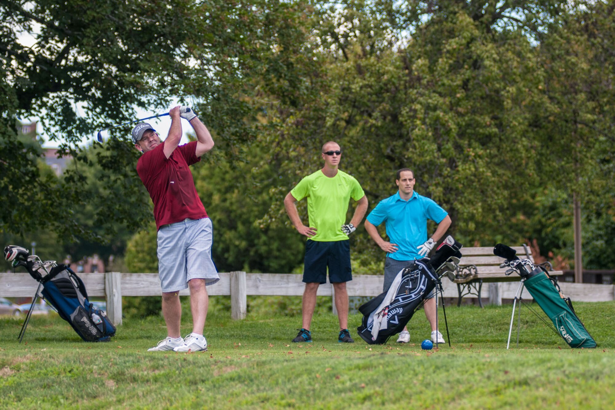 BEDFORD, Mass. – Joseph Peloquin, Space Fence Supervisory Acquisition Program Manager, tees off on the fifth hole while Captains Kyle Larson (left) and John Scavone look on during the Hanscom Intramural Golf tournament held at the Patriot Golf Course Aug. 6. (U.S. Air Force photo by Rick Berry)