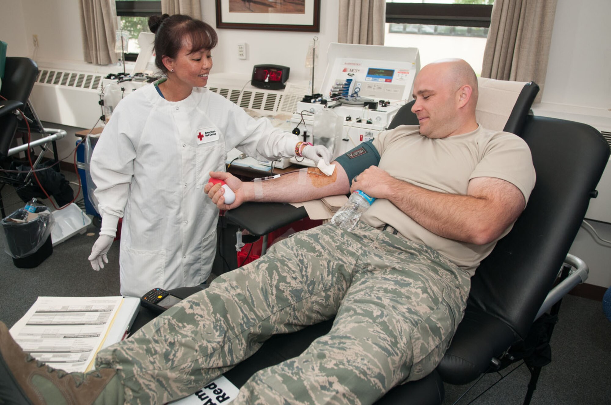 HANSCOM AIR FORCE BASE, Mass.--Sopheata Tan (left), from the American Red Cross, draws double red blood cells from Master Sgt. Terry LaBreck, 46 Test Squadron, Detachment 1 on Aug. 7 at the Hanscom Conference center. The Red Cross identified an urgent need for blood donations and this is their quarterly visit to Hanscom. (U.S. Air Force photo by Rick Berry)