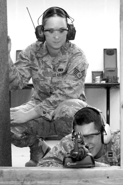 HANSCOM AIR FORCE BASE, Mass. -- Staff Sgt. Brandee L. Hahn, 66th Security Forces Squadron Combat Arms Training and Maintenance instructor, watches over Capt. Kevin Reinholz, Air Force Research Laboratory, Rome, N.Y., who was qualifying during an M-4 Carbine weapons system qualification class Aug 1 prior to deployment. The class was held at the CATM range where personnel learn a basic knowledge of the weapon and prepare for deployment. (U.S. Air Force photo by Linda LaBonte Britt)