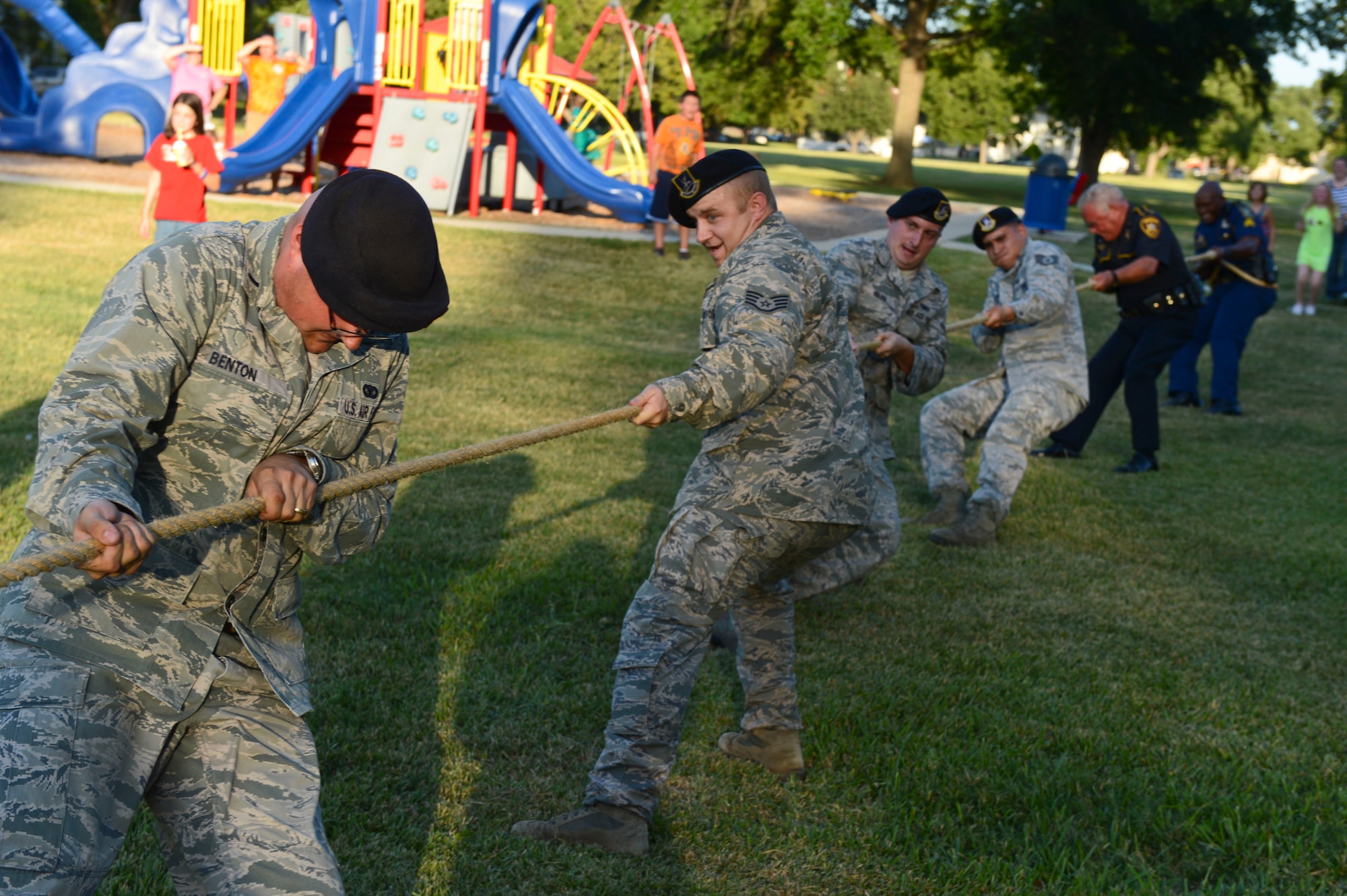 Airmen from the 2nd Security Forces Squadron and policemen from the Louisiana State Police Troop G join forces in a tug-of-war battle against Airmen from the Barksdale Fire Department during National Night Out on Barksdale Air Force Base, La., Aug. 6, 2013. Despite the fire department's valiant effort, the law enforcement duo won the challenge. The battle was held to boost morale and camaraderie between the units. (U.S. Air Force photo/Senior Airman Micaiah Anthony)