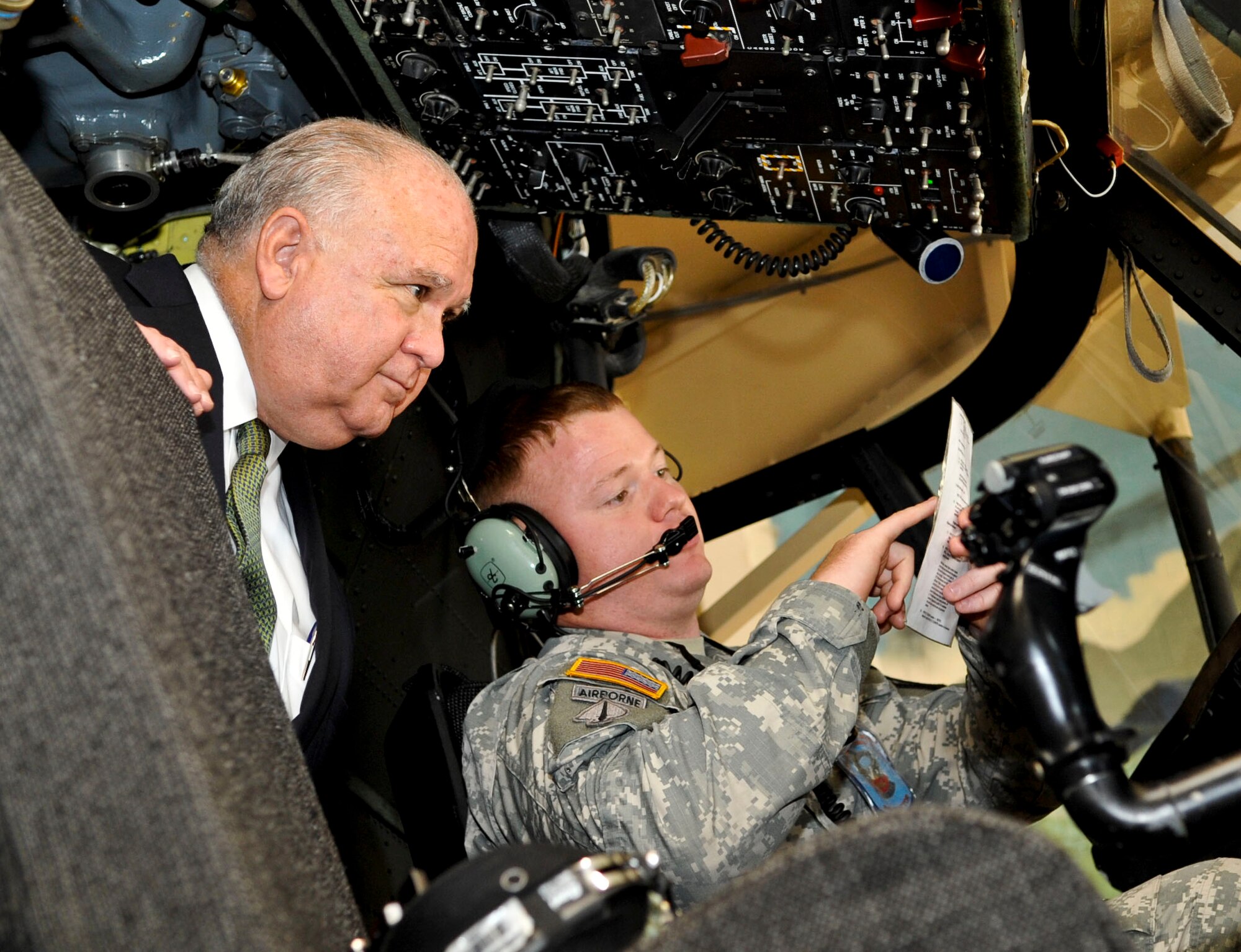 U.S. Army Staff Sgt. Scott Kirchman, 128th Aviation Brigade instructor, demonstrates for Under Secretary of the Army Joseph W. Westphal, how to troubleshoot a fault on a Chinook helicopter at Fort Eustis, Va., August 7, 2013. The 128th Aviation Brigade is responsible for training Serivce members on how to maintain a variety of different helicopters. (U.S. Air Force photo by Staff Sgt. Wesley Farnsworth/Released)