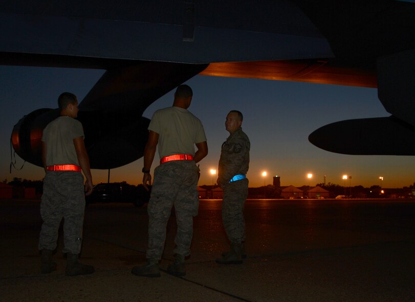 Master Sgt. Kyle Monroe, right, 20th Aircraft Maintenance Unit production superintendent, discusses  maintenance updates on a B-52H Stratofortress with Senior Airmen Nicholas Isambert and Justin Miller, both from the 2nd Aircraft Maintenance Squadron, on the flightline at Barksdale Air Force Base, La., Aug. 5, 2013. Many squadrons use round-the-clock vigilance to ensure the 2nd Bomb Wing mission is completed. (U.S. Air Force photo/Staff Sgt. Amber Corcoran)