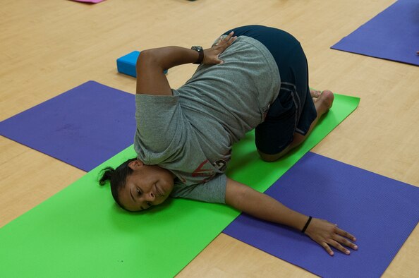 U.S. Air Force Staff Sgt. Iris McDowell twists into a pose during a yoga class at Moody Air Force Base, Ga., July 30, 2013. Twisting poses help improve the spine’s range of motion. (U.S. Air Force photo by Airman 1st Class Sandra Marrero/released)
