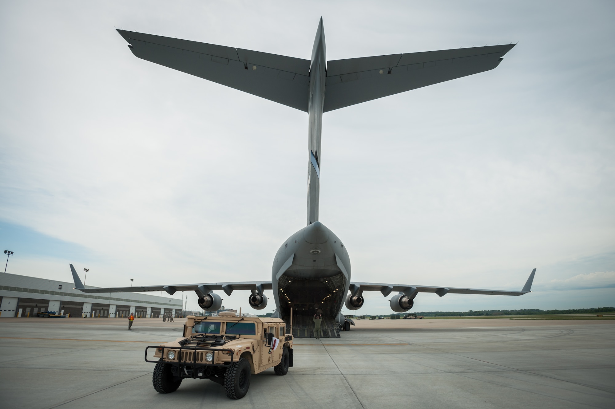 Members of the Kentucky Air National Guard’s 123rd Contingency Response Group offload a Humvee from a Mississippi Air National Guard C-17 at MidAmerica St. Louis Airport in Mascoutah, Ill., on Aug. 6, 2013, as part of Exercise Gateway Relief, a U.S. Transportation Command-directed earthquake-response scenario. The 123rd is joining forces with the U.S. Army’s active-duty 689th Rapid Port Opening Element from Fort Eustis, Va., to stand up and operate a Joint Task Force-Port Opening through Aug. 9. A JTF-PO, which combines an Air Force Aerial Port of Debarkation with an Army trucking and distribution unit, ensures the smooth flow of relief supplies into affected areas by airlift, and coordinates their final distribution over land. (U.S. Air National Guard photo by Maj. Dale Greer)