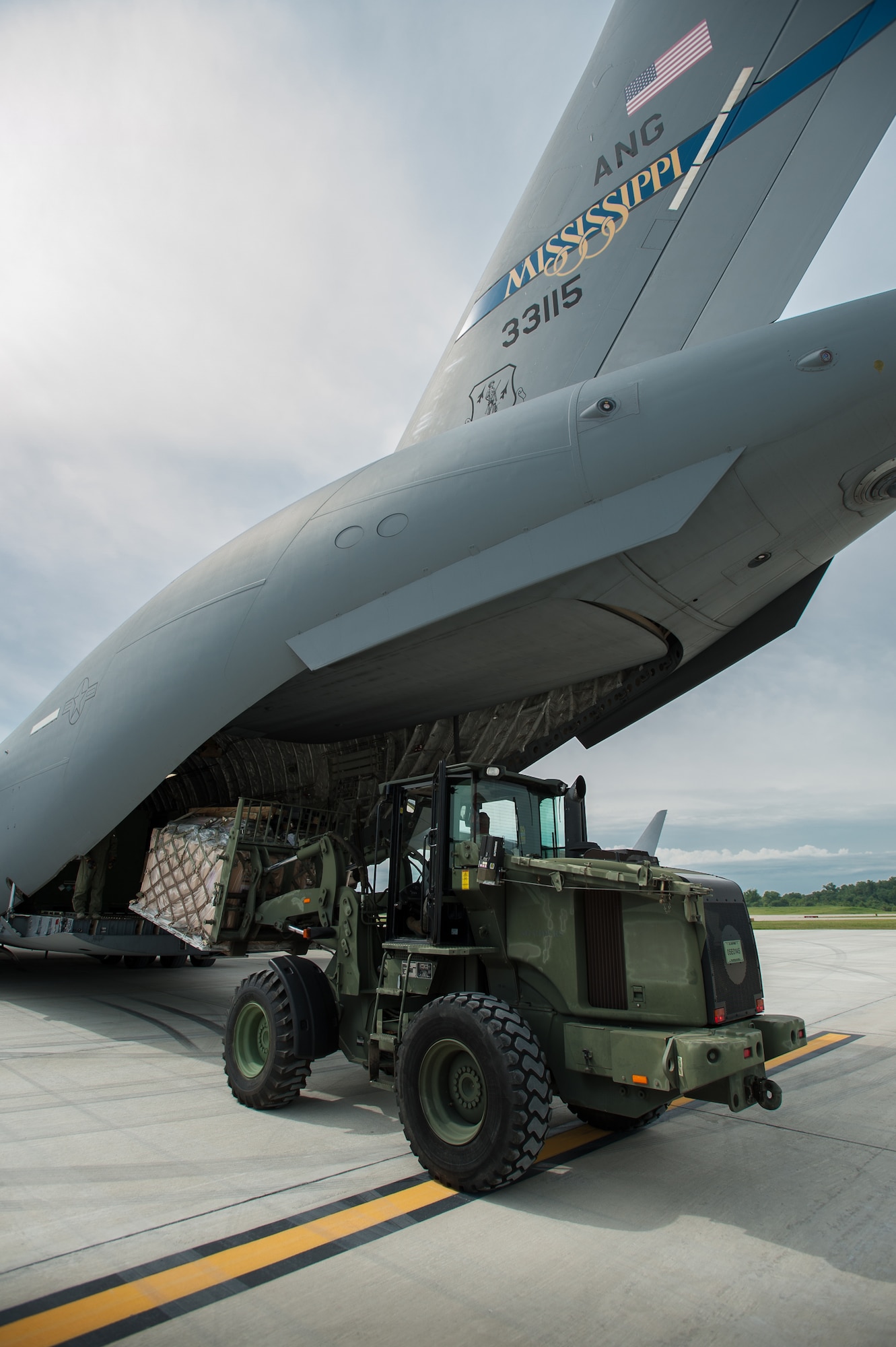 Members of the Kentucky Air National Guard’s 123rd Contingency Response Group offload equipment from a Mississippi Air National Guard C-17 at MidAmerica St. Louis Airport in Mascoutah, Ill., on Aug. 6, 2013, as part of Exercise Gateway Relief, a U.S. Transportation Command-directed earthquake-response scenario. The 123rd is joining forces with the U.S. Army’s active-duty 689th Rapid Port Opening Element from Fort Eustis, Va., to stand up and operate a Joint Task Force-Port Opening through Aug. 9. A JTF-PO, which combines an Air Force Aerial Port of Debarkation with an Army trucking and distribution unit, ensures the smooth flow of relief supplies into affected areas by airlift, and coordinates their final distribution over land. (U.S. Air National Guard photo by Maj. Dale Greer)