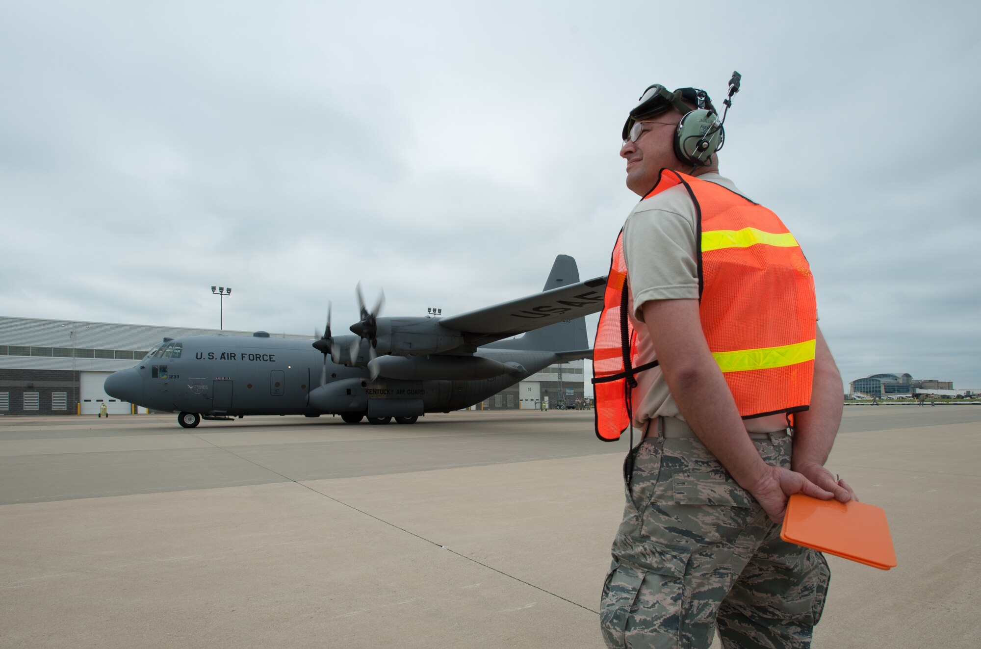 Master Sgt. James Nally, a flight chief for the Kentucky Air National Guard’s 123rd Contingency Response Group, directs a C-130 to its parking spot at MidAmerica St. Louis Airport in Mascoutah, Ill., on Aug. 5, 2013, as part of Exercise Gateway Relief, a U.S. Transportation Command-directed earthquake-response scenario. The 123rd is joining forces with the U.S. Army’s active-duty 689th Rapid Port Opening Element from Fort Eustis, Va., to stand up and operate a Joint Task Force-Port Opening, which combines an Air Force Aerial Port of Debarkation with an Army trucking and distribution unit. The aerial port ensures the smooth flow of cargo and relief supplies into affected areas by airlift, while the trucking unit facilitates their final distribution over land. (U.S. Air National Guard photo by Maj. Dale Greer)