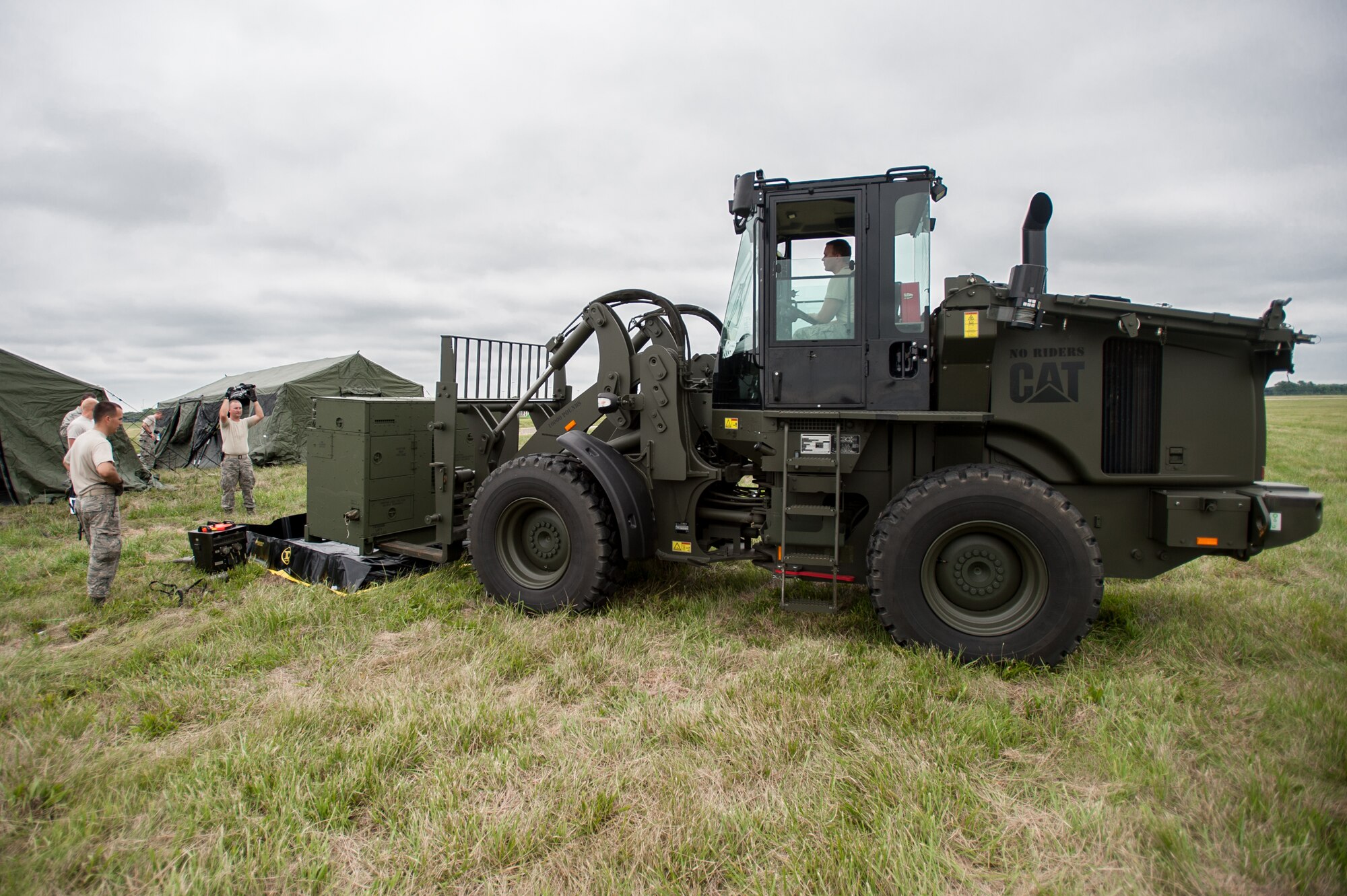 Airmen from the Kentucky Air National Guard’s 123rd Contingency Response Group place a generator during camp build-up at MidAmerica St. Louis Airport in Mascoutah, Ill., on Aug. 5, 2013, as part of Exercise Gateway Relief, a U.S. Transportation Command-directed earthquake-response scenario. The 123rd is joining forces with the U.S. Army’s active-duty 689th Rapid Port Opening Element from Fort Eustis, Va., to stand up and operate a Joint Task Force-Port Opening, which combines an Air Force Aerial Port of Debarkation with an Army trucking and distribution unit. The aerial port ensures the smooth flow of cargo and relief supplies into affected areas by airlift, while the trucking unit facilitates their final distribution over land. (U.S. Air National Guard photo by Maj. Dale Greer)