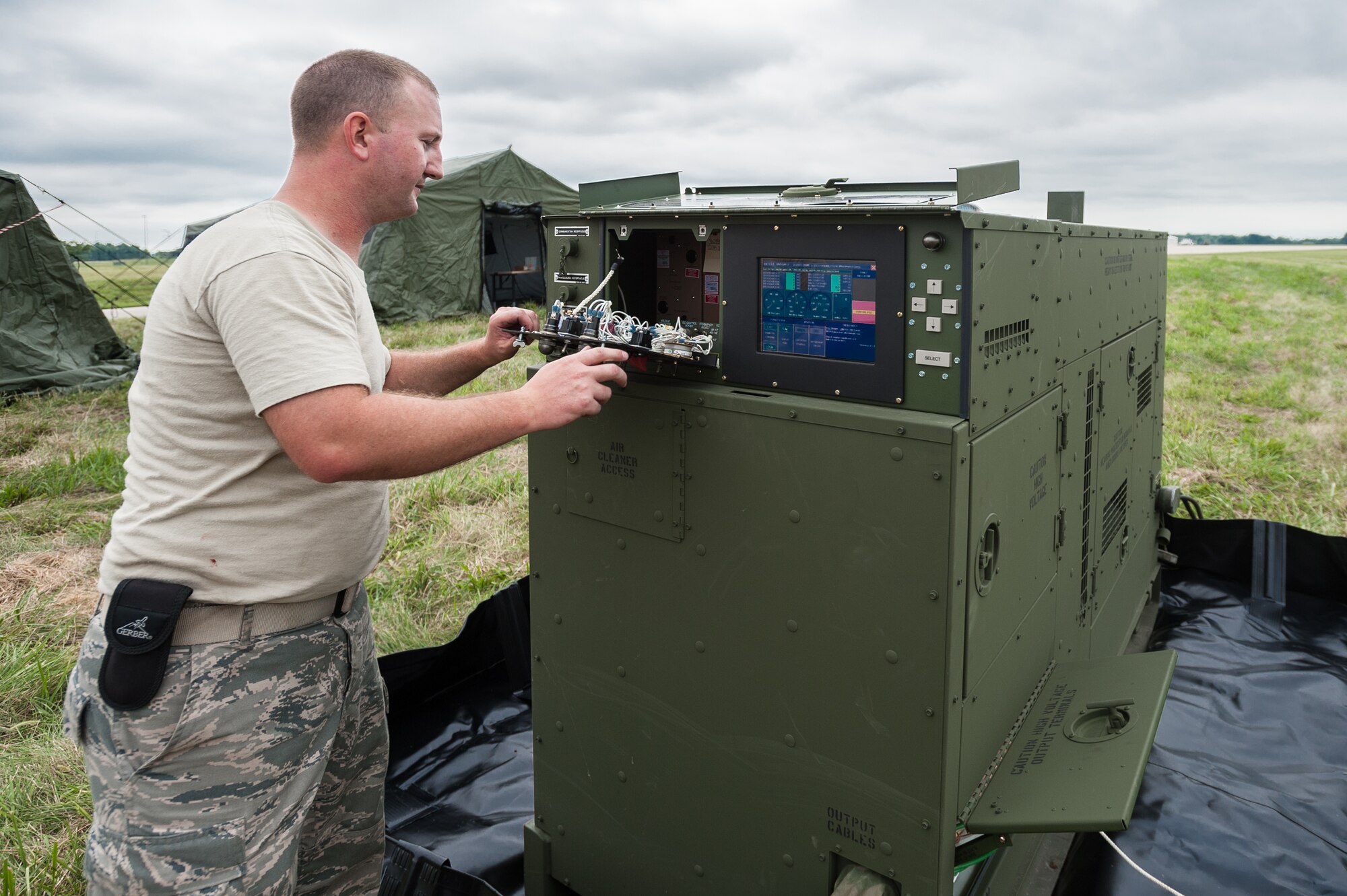 Tech. Sgt. Robert Shipp, an aerospace ground equipment specialist from the Kentucky Air National Guard’s 123rd Contingency Response Group, prepares a 60-kilowatt electric generator during camp build-up at MidAmerica St. Louis Airport in Mascoutah, Ill., on Aug. 5, 2013, as part of Exercise Gateway Relief, a U.S. Transportation Command-directed earthquake-response scenario. The 123rd is joining forces with the U.S. Army’s active-duty 689th Rapid Port Opening Element from Fort Eustis, Va., to stand up and operate a Joint Task Force-Port Opening, which combines an Air Force Aerial Port of Debarkation with an Army trucking and distribution unit. The aerial port ensures the smooth flow of cargo and relief supplies into affected areas by airlift, while the trucking unit facilitates their final distribution over land. (U.S. Air National Guard photo by Maj. Dale Greer)