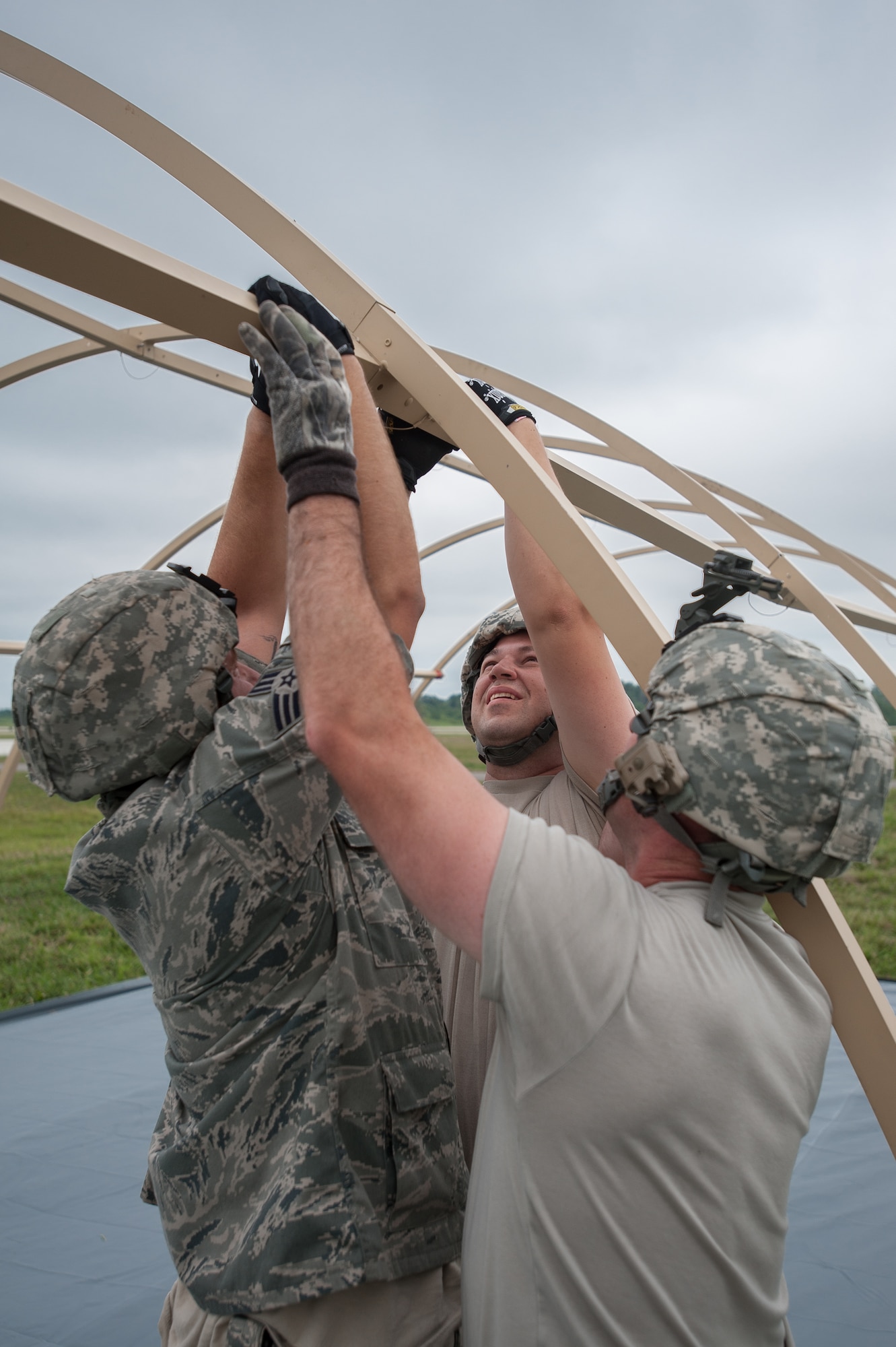 Airmen from the Kentucky Air National Guard’s 123rd Contingency Response Group and Soldiers from the U.S. Army’s active-duty 689th Rapid Port Opening Element from Fort Eustis, Va., erect Alaskan Shelter sleeping quarters at MidAmerica St. Louis Airport in Mascoutah, Ill., on Aug. 5, 2013, as part of Exercise Gateway Relief, a U.S. Transportation Command-directed earthquake-response scenario. The two units are joining forces to stand up and operate a Joint Task Force-Port Opening, which combines an Air Force Aerial Port of Debarkation with an Army trucking and distribution unit. The aerial port ensures the smooth flow of cargo and relief supplies into affected areas by airlift, while the trucking unit facilitates their final distribution over land. (U.S. Air National Guard photo by Maj. Dale Greer)