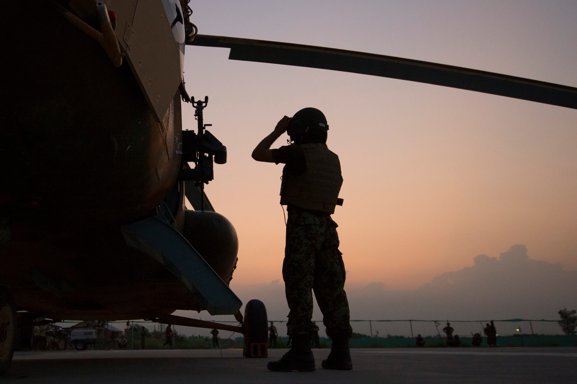 An Afghan Air Force aerial gunner preflights an Mi-17 helicopter as the sun rises at Jalalabad Airfield, Afghanistan, on the first day of Operation Seemorgh, July 23, 2013. Operation Seemorgh, named after a mythical bird, is the largest Afghan-led combat operation in more than 30 years, combining air and ground forces in an offensive focused on Taliban in Loghar Province. (U.S. Air Force Photo/Master Sgt. Ben Bloker)