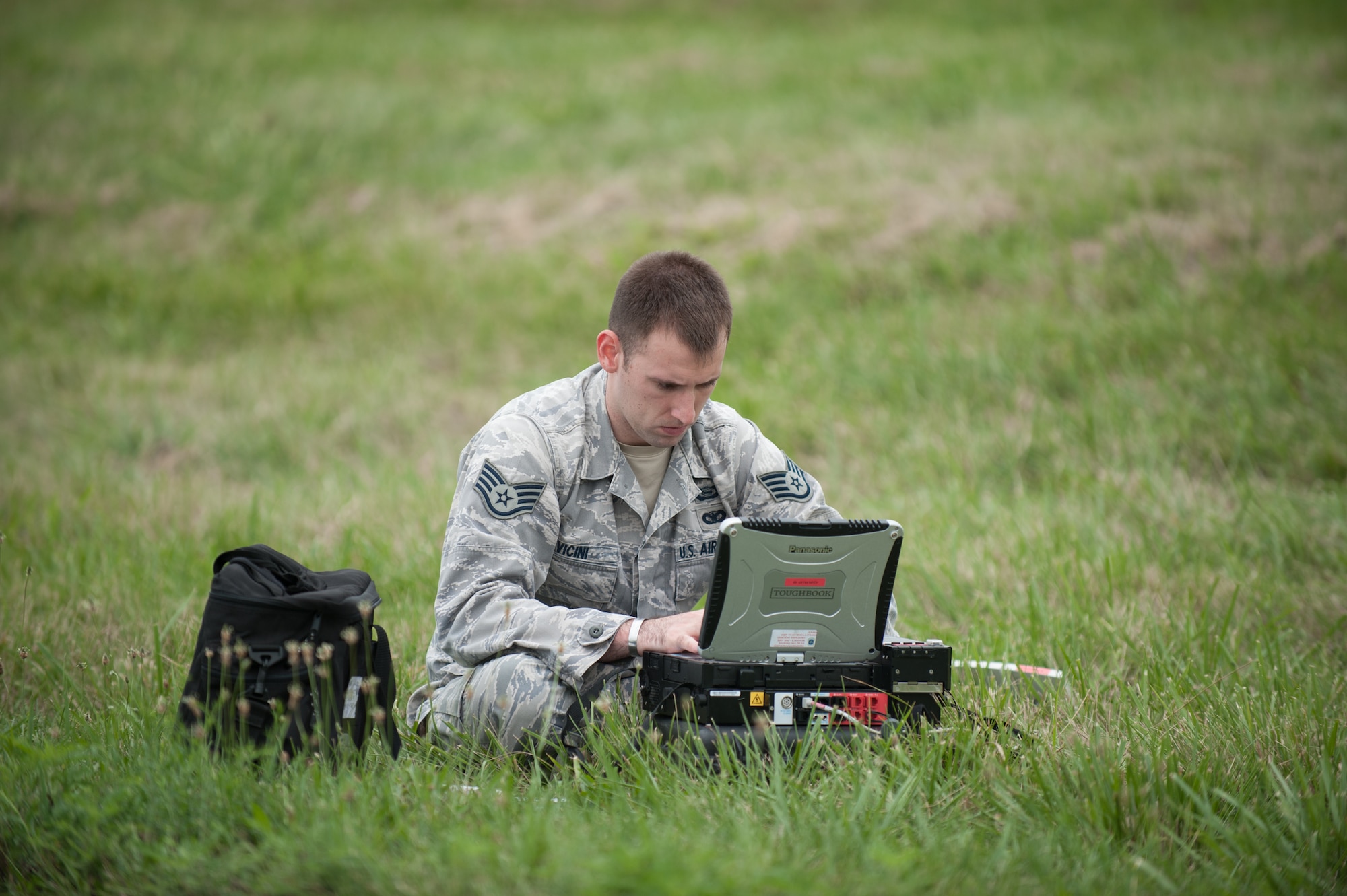 Staff Sgt. Pete Vicini, an intelligence analyst from the Kentucky Air National Guard’s 123rd Contingency Response Group, sends encrypted mission updates to U.S. Transportation Command officials from MidAmerica St. Louis Airport in Mascoutah, Ill., on Aug. 5, 2013, as part of Exercise Gateway Relief, a U.S. Transportation Command-directed earthquake-response scenario. The 123rd is joining forces with the U.S. Army’s active-duty 689th Rapid Port Opening Element from Fort Eustis, Va., to stand up and operate a Joint Task Force-Port Opening, which combines an Air Force Aerial Port of Debarkation with an Army trucking and distribution unit. The aerial port ensures the smooth flow of cargo and relief supplies into affected areas by airlift, while the trucking unit facilitates their final distribution over land. (U.S. Air National Guard photo by Maj. Dale Greer)