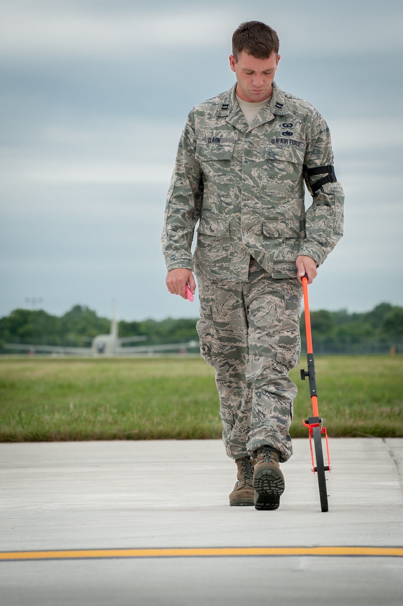 Capt. Jeff Clark, an airfield management officer from the Kentucky Air National Guard’s 123rd Contingency Response Group, measures the flight line to determine an aircraft parking plan at MidAmerica St. Louis Airport in Mascoutah, Ill., on Aug. 5, 2013, as part of Exercise Gateway Relief, a U.S. Transportation Command-directed earthquake-response scenario. The 123rd is joining forces with the U.S. Army’s active-duty 689th Rapid Port Opening Element from Fort Eustis, Va., to stand up and operate a Joint Task Force-Port Opening, which combines an Air Force Aerial Port of Debarkation with an Army trucking and distribution unit. The aerial port ensures the smooth flow of cargo and relief supplies into affected areas by airlift, while the trucking unit facilitates their final distribution over land. (U.S. Air National Guard photo by Maj. Dale Greer)