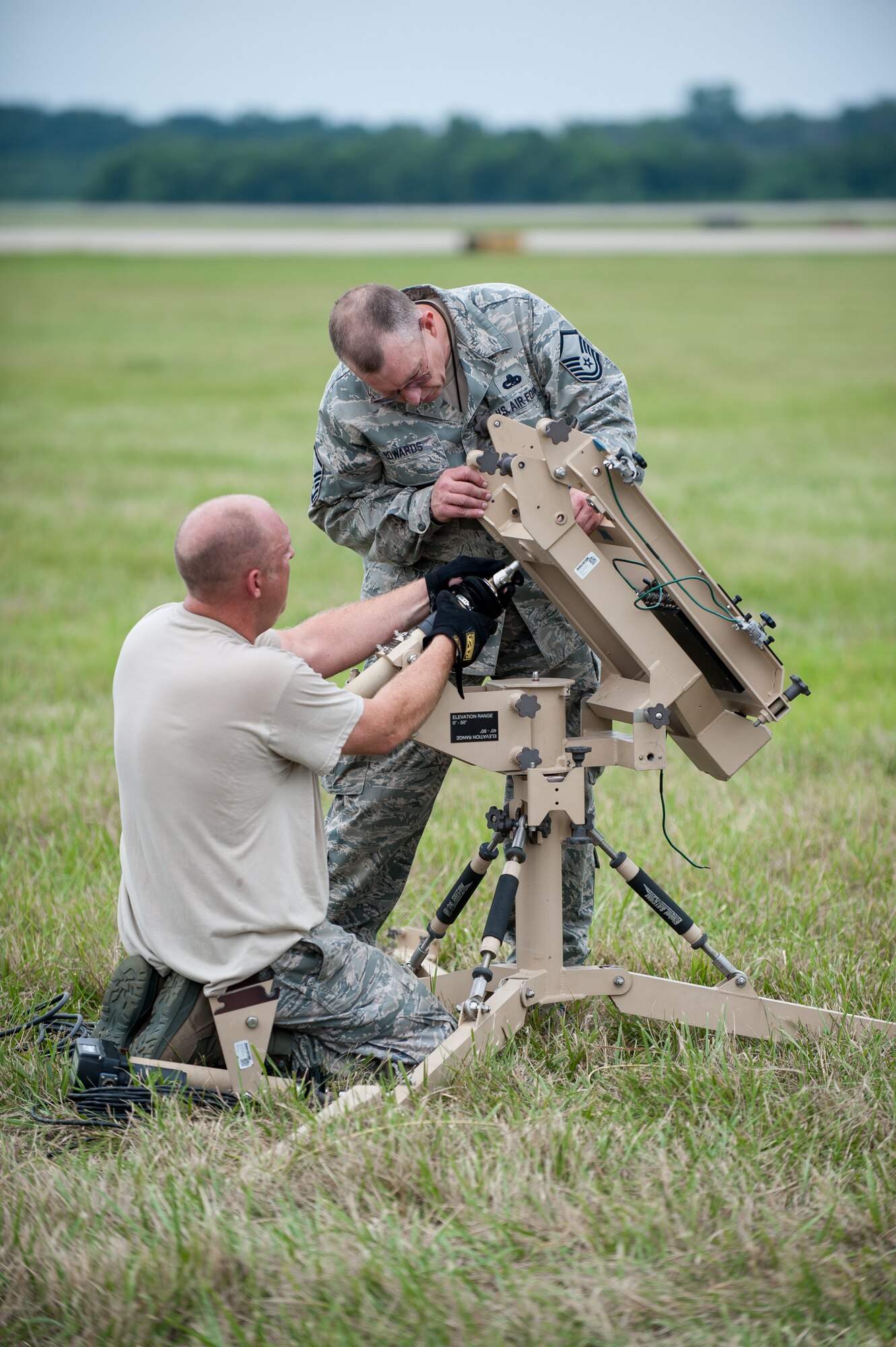 Master Sgt. Paul Edwards (right), a cybertransport supervisor with the Kentucky Air National Guard’s 123rd Contingency Response Group, helps Tech. Sgt. Kyle Goins, a 123rd communications specialist, assemble a satellite communications antenna at MidAmerica St. Louis Airport in Mascoutah, Ill., on Aug. 5, 2013, as part of Exercise Gateway Relief, a U.S. Transportation Command-directed earthquake-response scenario. The 123rd is joining forces with the U.S. Army’s active-duty 689th Rapid Port Opening Element from Fort Eustis, Va., to stand up and operate a Joint Task Force-Port Opening, which combines an Air Force Aerial Port of Debarkation with an Army trucking and distribution unit. The aerial port ensures the smooth flow of cargo and relief supplies into affected areas by airlift, while the trucking unit facilitates their final distribution over land. (U.S. Air National Guard photo by Maj. Dale Greer)