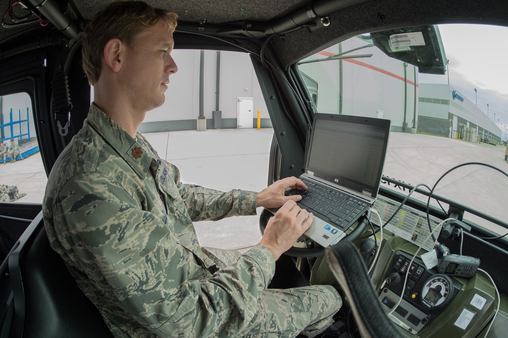 Maj. Ryan Adams, airflow operations officer for the Kentucky Air National Guard’s 123rd Contingency Response Group, monitors airlift missions from a mobile command post at MidAmerica St. Louis Airport in Mascoutah, Ill., on Aug. 5, 2013, as part of Exercise Gateway Relief, a U.S. Transportation Command-directed earthquake-response scenario. The 123rd is joining forces with the U.S. Army’s active-duty 689th Rapid Port Opening Element from Fort Eustis, Va., to stand up and operate a Joint Task Force-Port Opening, which combines an Air Force Aerial Port of Debarkation with an Army trucking and distribution unit. The aerial port ensures the smooth flow of cargo and relief supplies into affected areas by airlift, while the trucking unit facilitates their final distribution over land. (U.S. Air National Guard photo by Maj. Dale Greer)
